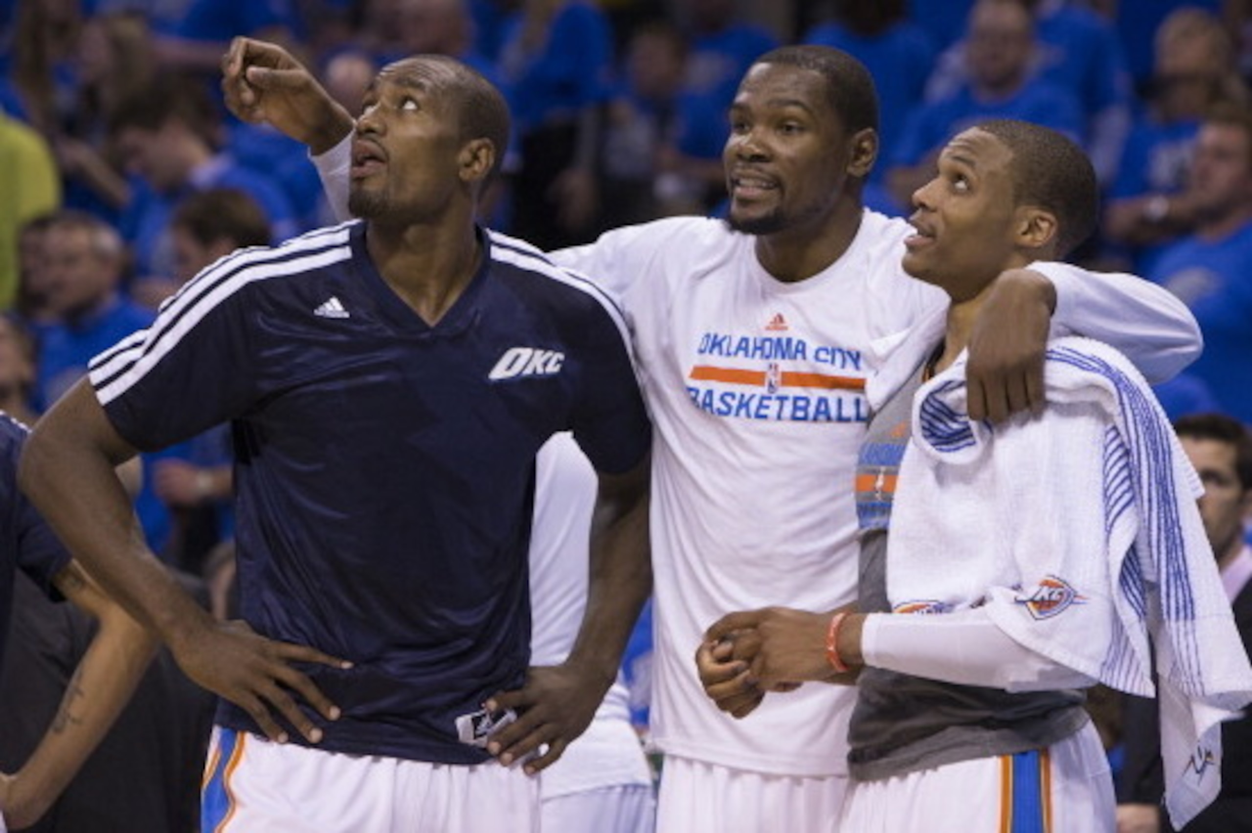 OKLAHOMA CITY, OK - APRIL 19:  Serge Ibaka #9, Kevin Durant #35 and Russell Westbrook #0 of the Oklahoma City Thunder talk during the Memphis Grizzlies in Game One of the Western Conference Quarterfinals of the NBA Playoffs at Chesapeake Energy Arena on A