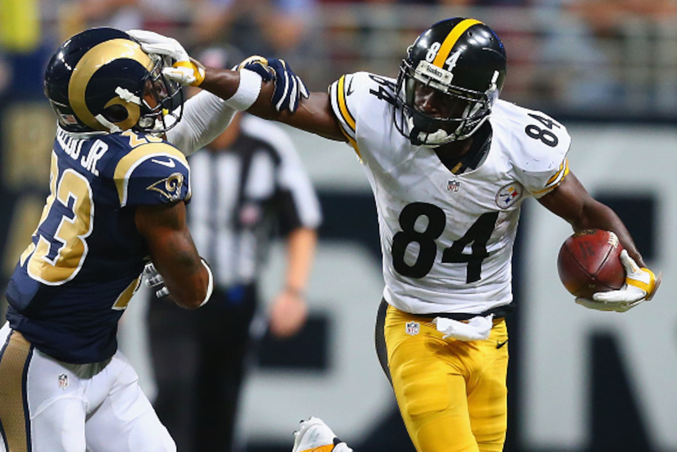 ST. LOUIS, MO - SEPTEMBER 27: Antonio Brown #84 of the Pittsburgh Steelers avoids being tackled by Rodney McLeod #23 of the St. Louis Rams in the third quarter at the Edward Jones Dome on September 27, 2015 in St. Louis, Missouri.  (Photo by Dilip Vishwan