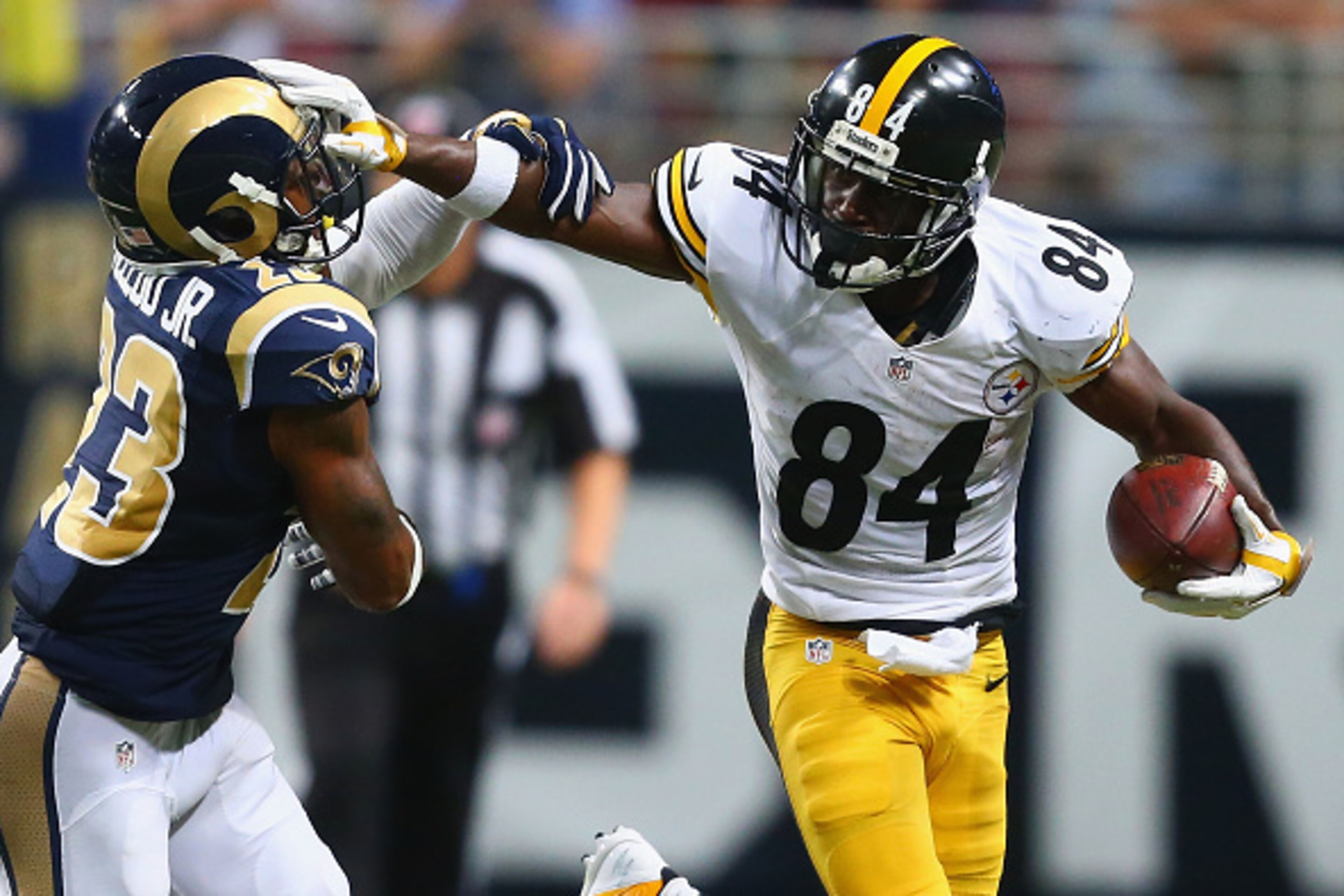 ST. LOUIS, MO - SEPTEMBER 27: Antonio Brown #84 of the Pittsburgh Steelers avoids being tackled by Rodney McLeod #23 of the St. Louis Rams in the third quarter at the Edward Jones Dome on September 27, 2015 in St. Louis, Missouri.  (Photo by Dilip Vishwan