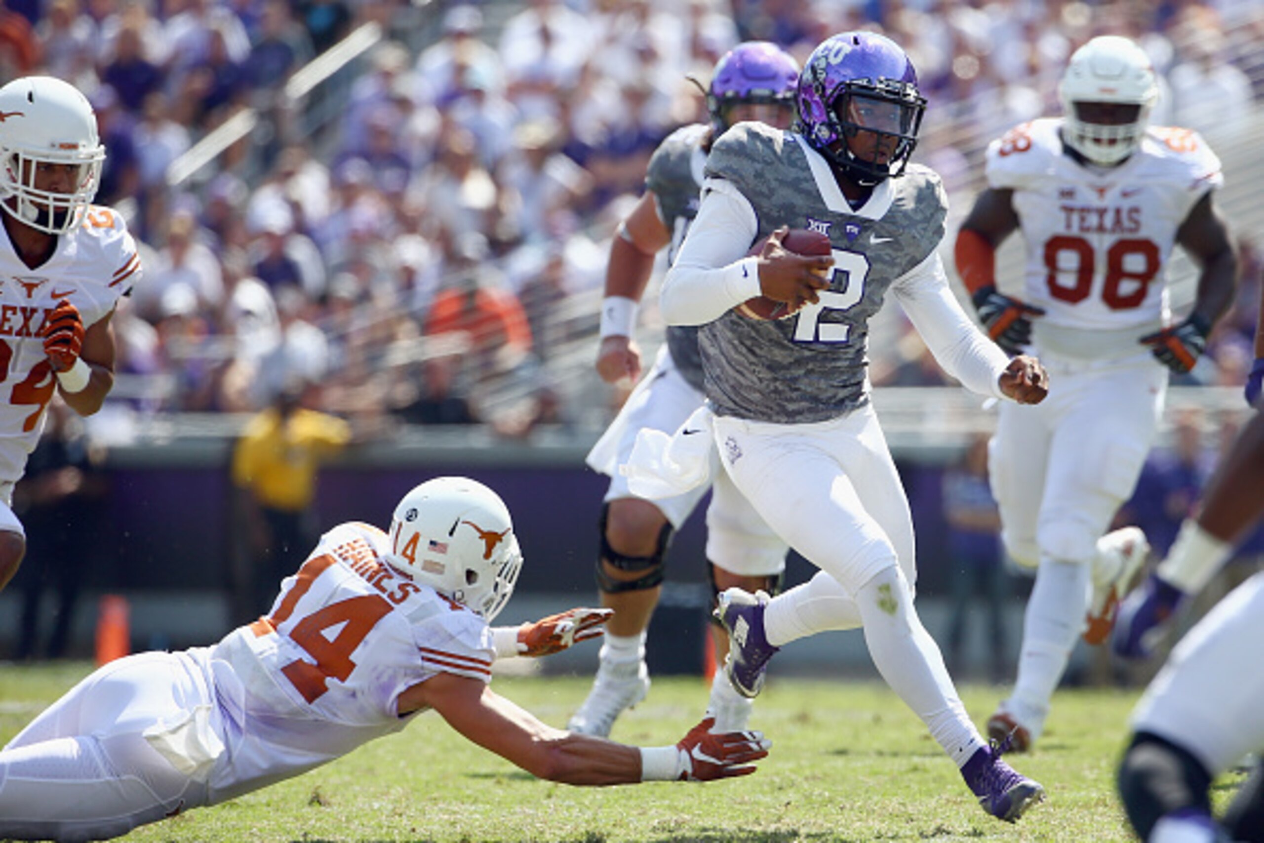 FORT WORTH, TX - OCTOBER 03:  Trevone Boykin #2 of the TCU Horned Frogs carries the ball against Dylan Haines #14 of the Texas Longhorns in the third quarter at Amon G. Carter Stadium on October 3, 2015 in Fort Worth, Texas.  (Photo by Tom Pennington/Gett