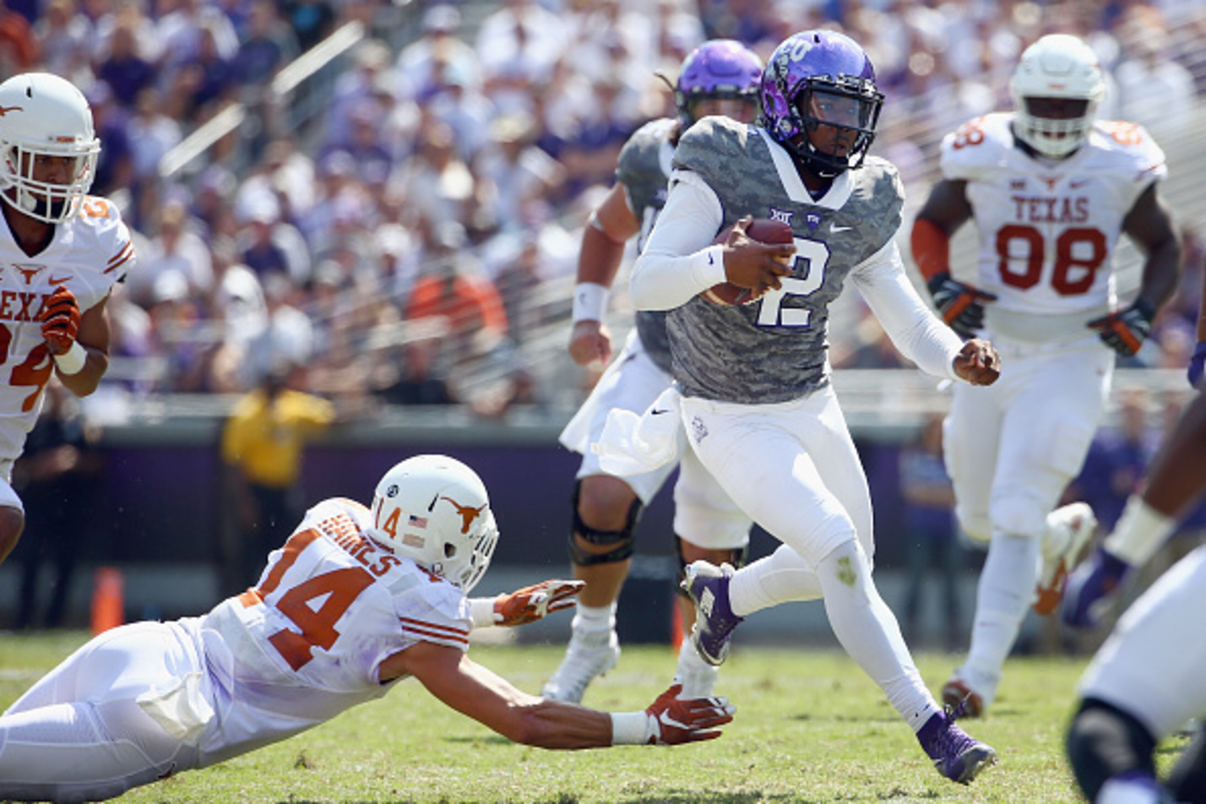 FORT WORTH, TX - OCTOBER 03:  Trevone Boykin #2 of the TCU Horned Frogs carries the ball against Dylan Haines #14 of the Texas Longhorns in the third quarter at Amon G. Carter Stadium on October 3, 2015 in Fort Worth, Texas.  (Photo by Tom Pennington/Gett