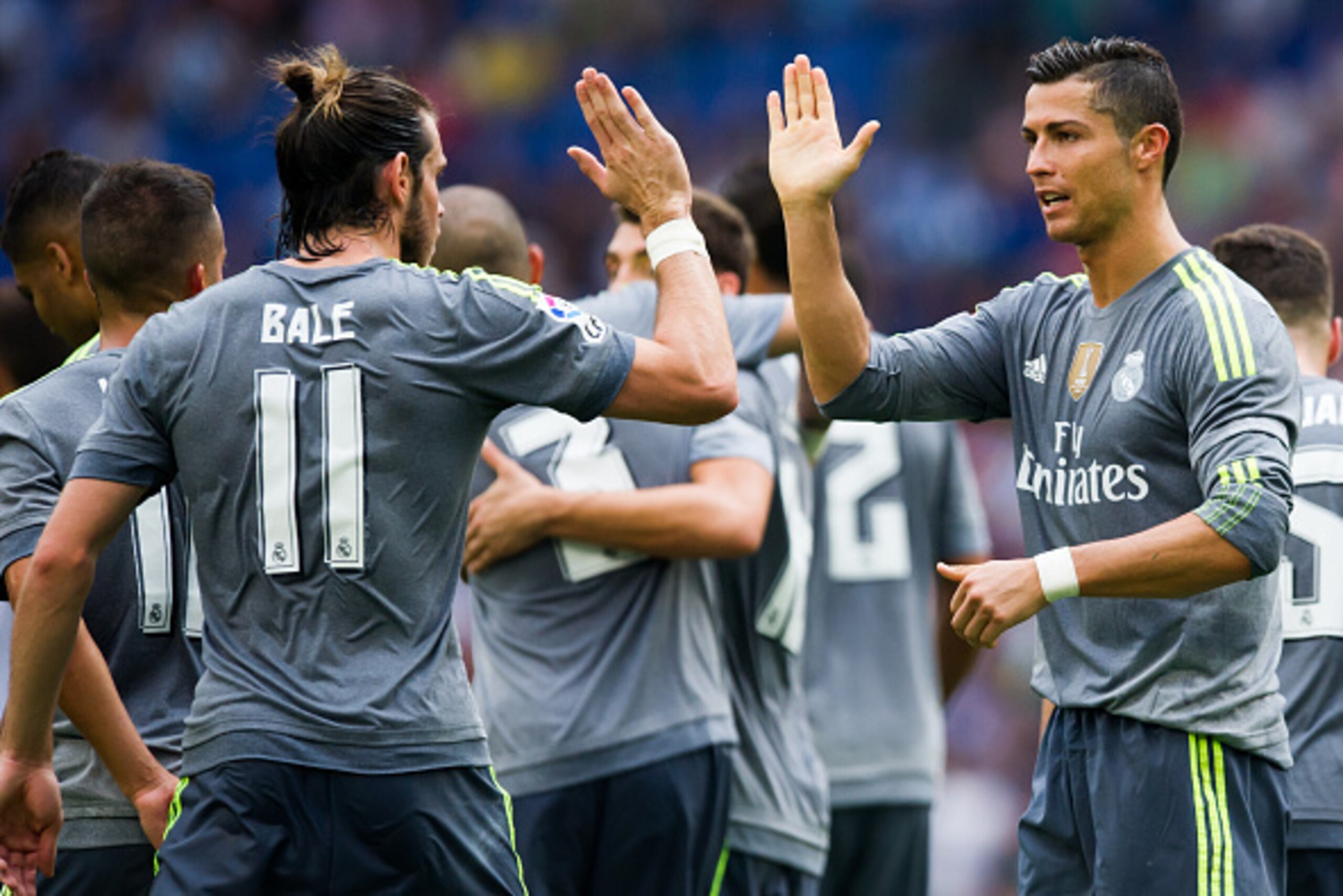 BARCELONA, SPAIN - SEPTEMBER 12: Cristiano Ronaldo (R) of Real Madrid CF is congratulated by his teammate Gareth Bale (L) after scoring his team's sixth goal during the La Liga match between RCD Espanyol and Real Madrid CF at Cornella-El Prat Stadium on S