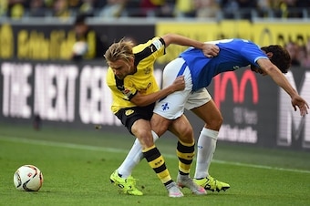 Darmstadt's midfielder Marcel Heller and Dortmund's defender Marcel Schmelzer (L) vie for the ball during the German first division Bundesliga football match Borussia Dortmund v SV Darmstadt 98, in Dortmund, western Germany, on September 27, 2015. AFP PHO