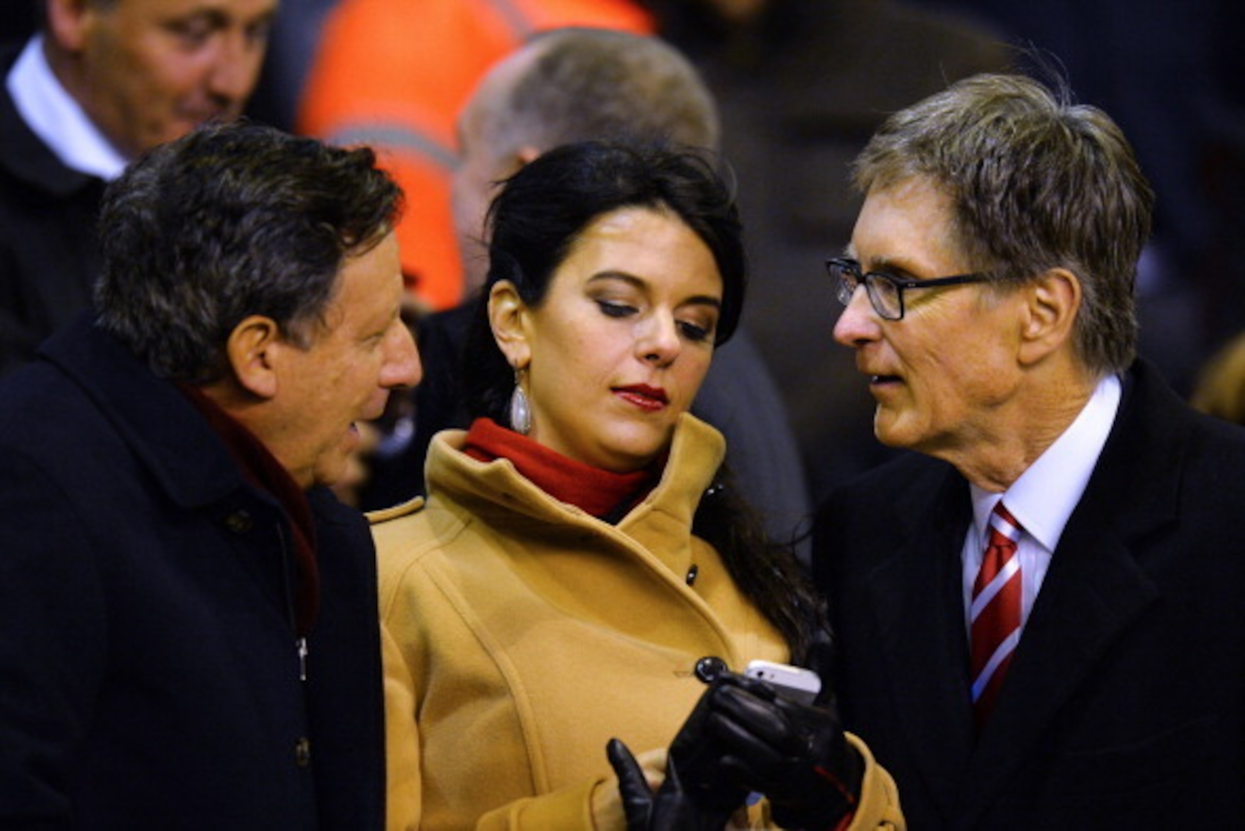 Liverpool's US owner John W Henry (R) talks with Liverpool chairman Tom Werner (L) as he arrives with wife Linda Pizzuti (C) to watch the English Premier League football match between Liverpool and Aston Villa at Anfield in Liverpool, northwest England, o