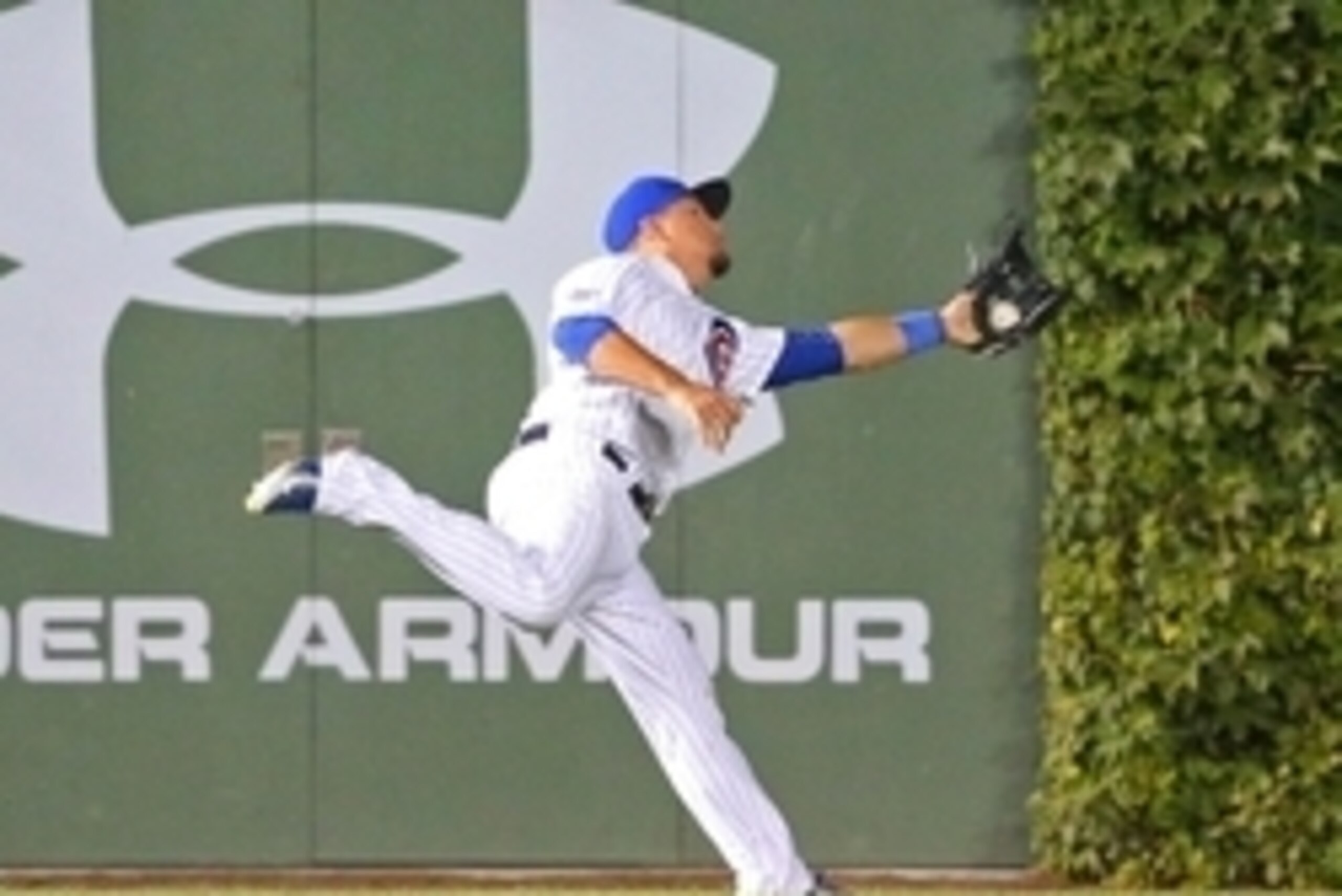 Sep 23, 2015; Chicago, IL, USA; Chicago Cubs left fielder Kyle Schwarber (12) makes a catch on  fly ball off the bat of Milwaukee Brewers catcher Martin Maldonado (not pictured) during the seventh inning at Wrigley Field. Mandatory Credit: Dennis Wierzbic