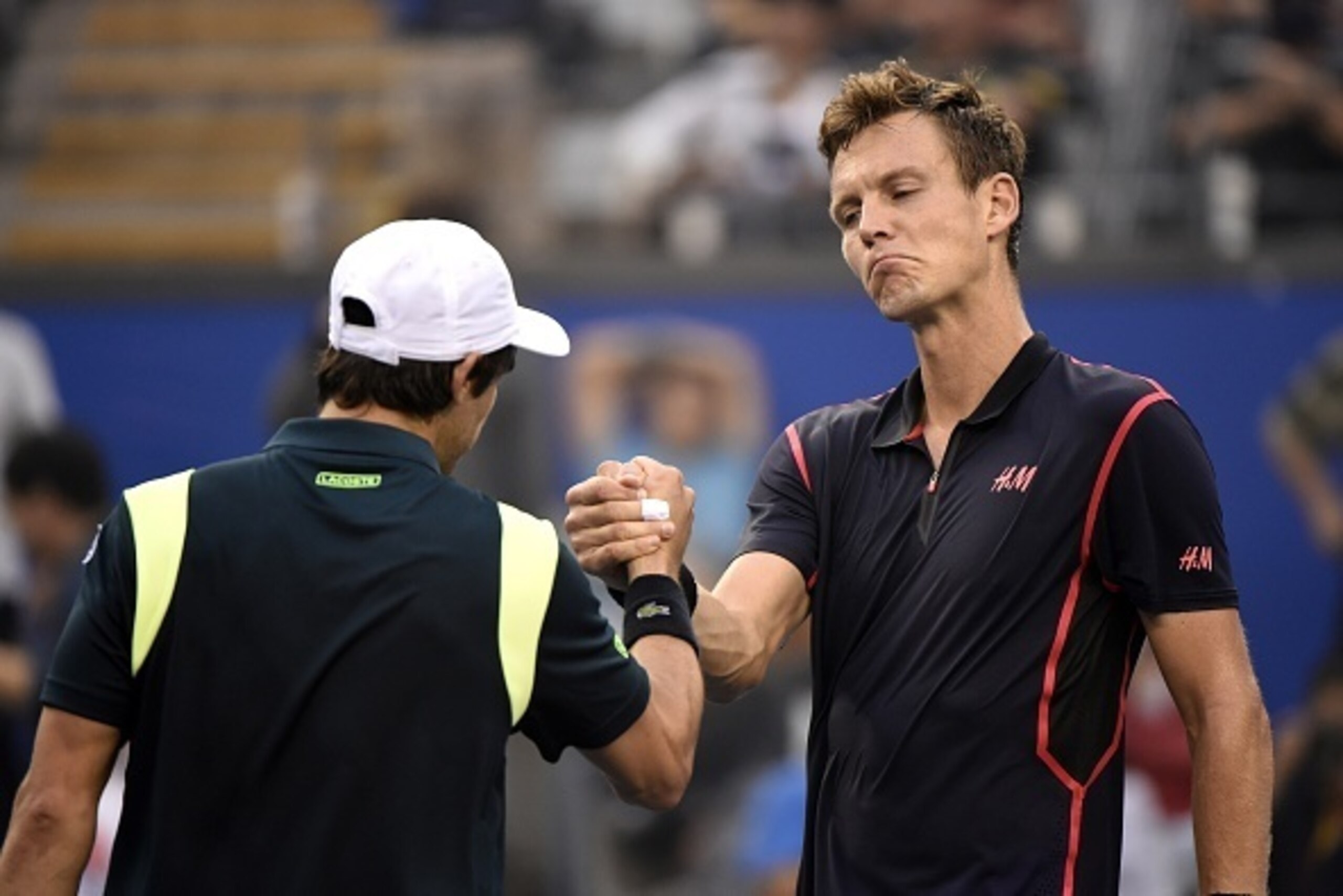 Pablo Cuevas (L) of Uruguay shakes hands with Tomas Berdych of the Czech Republic after winning their first round men's singles match at the China Open tennis tournament in Beijing on October 7, 2015. AFP PHOTO / FRED DUFOUR        (Photo credit should re