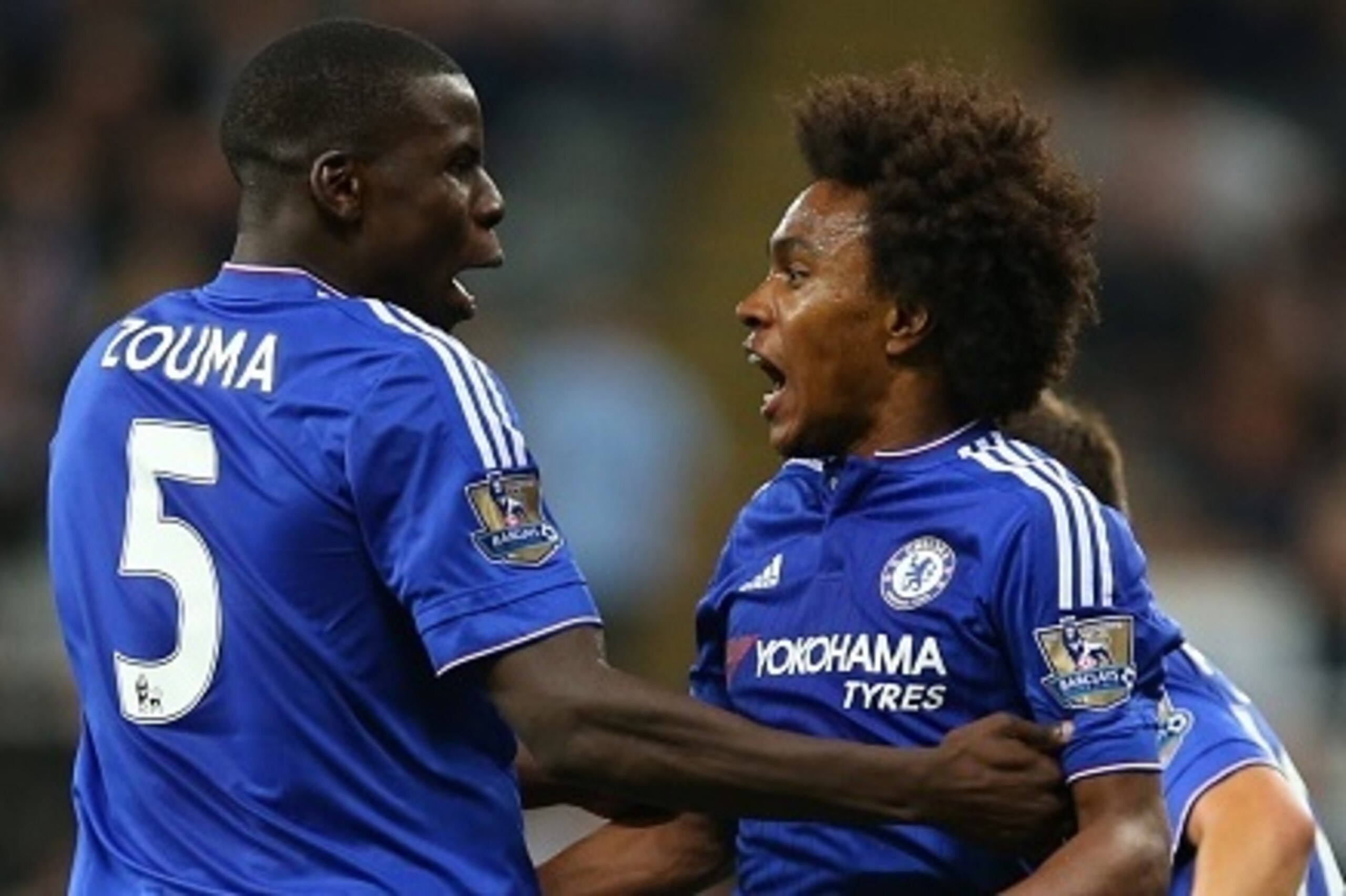 Chelseas Brazilian midfielder Willian celebrates with Chelsea's French defender Kurt Zouma (R) after scoring Chelsea's second goal during the English Premier League football match between Newcastle United and Chelsea at St James' Park in Newcastle-upon-Ty