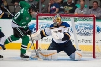 Sep 29, 2015; Dallas, TX, USA; St. Louis Blues goalie Brian Elliott (1) makes a save on a shot by Dallas Stars left wing Patrick Sharp (10) during the third period at the American Airlines Center. The Blues defeat the Stars 4-1.  Mandatory Credit: Jerome 