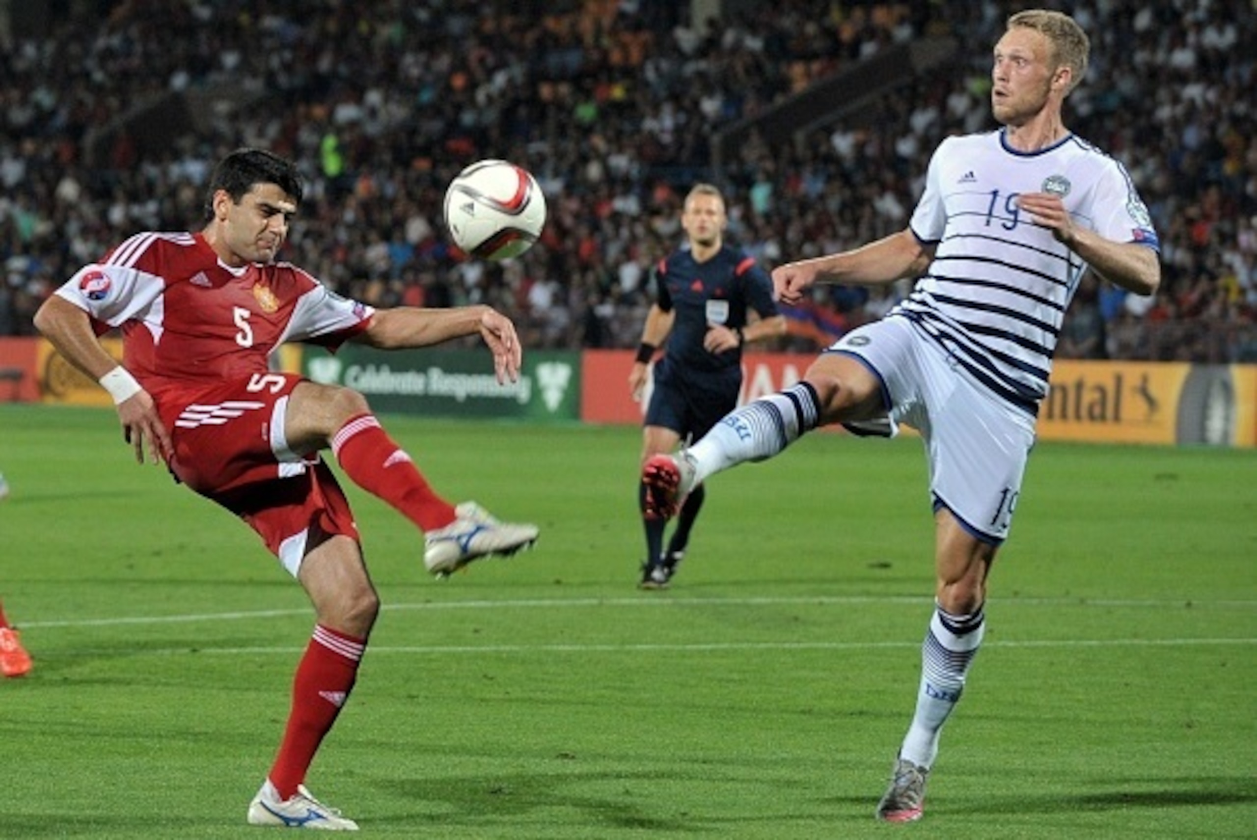 Armenia's defender Robert Arzumanyan (L) vies for the ball with Denmark's forward Nicolai Jorgensen during the Euro 2016 qualifying football match between Armenia and Denmark in Yerevan on September 7, 2015. AFP PHOTO / KAREN MINASYAN        (Photo credit