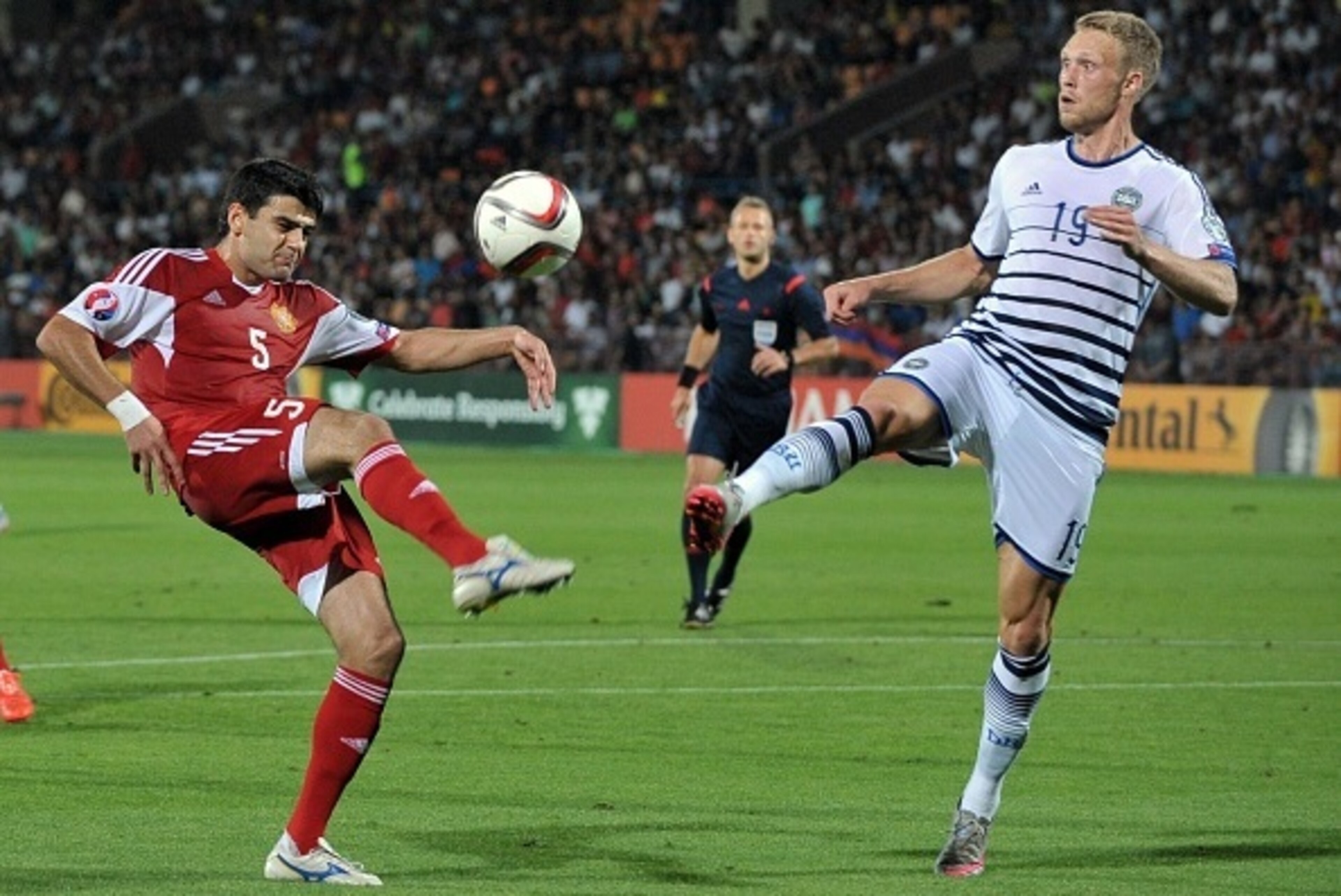 Armenia's defender Robert Arzumanyan (L) vies for the ball with Denmark's forward Nicolai Jorgensen during the Euro 2016 qualifying football match between Armenia and Denmark in Yerevan on September 7, 2015. AFP PHOTO / KAREN MINASYAN        (Photo credit