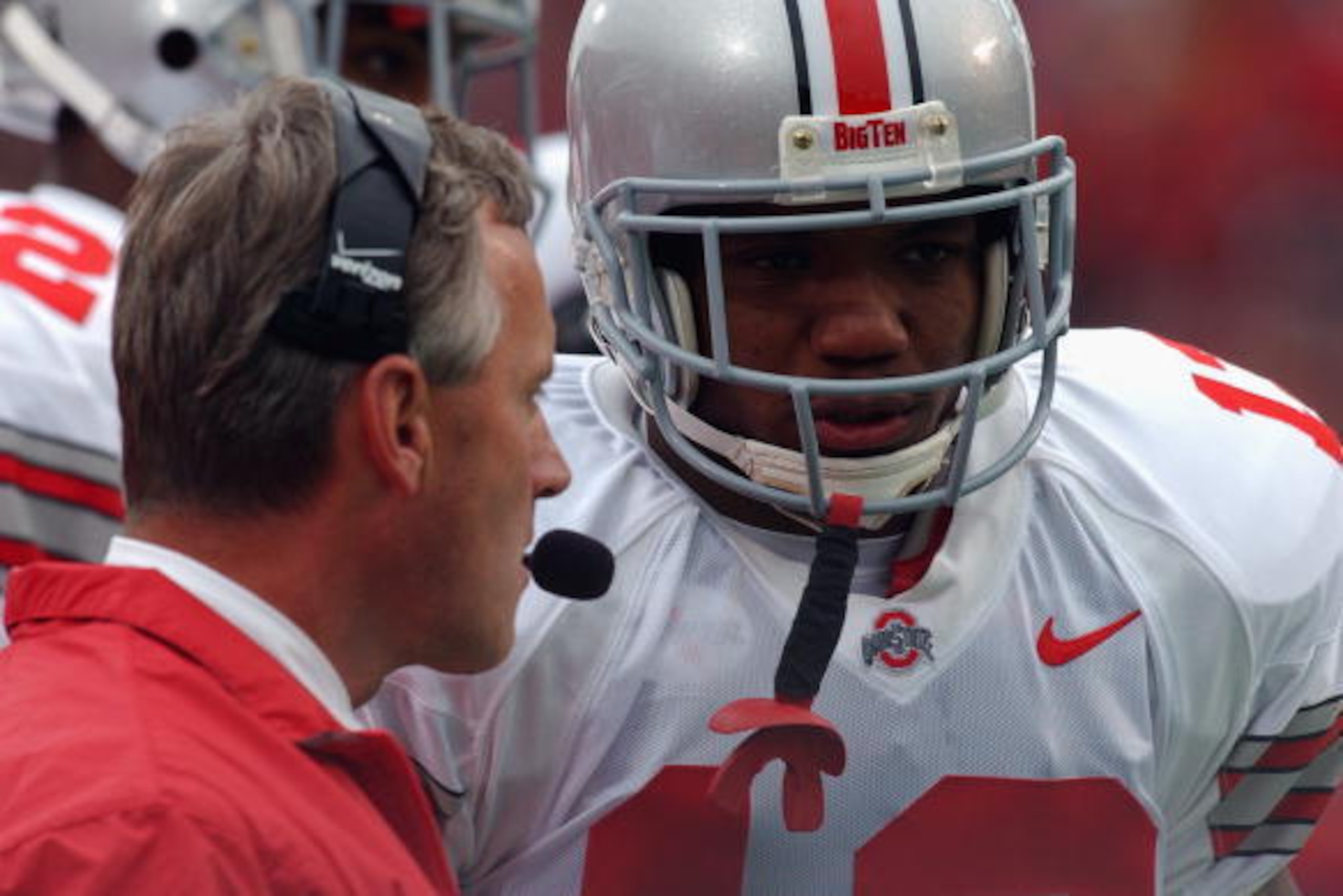MADISON, WI - OCTOBER 19:  Running back Maurice Clarett #13 of the Ohio State Buckeyes listens to head coach Jim Tressel during the Big Ten Conference football game against the Wisconsin Badgers at Camp Randall Stadium on October 19, 2002 in Madison, Wisc