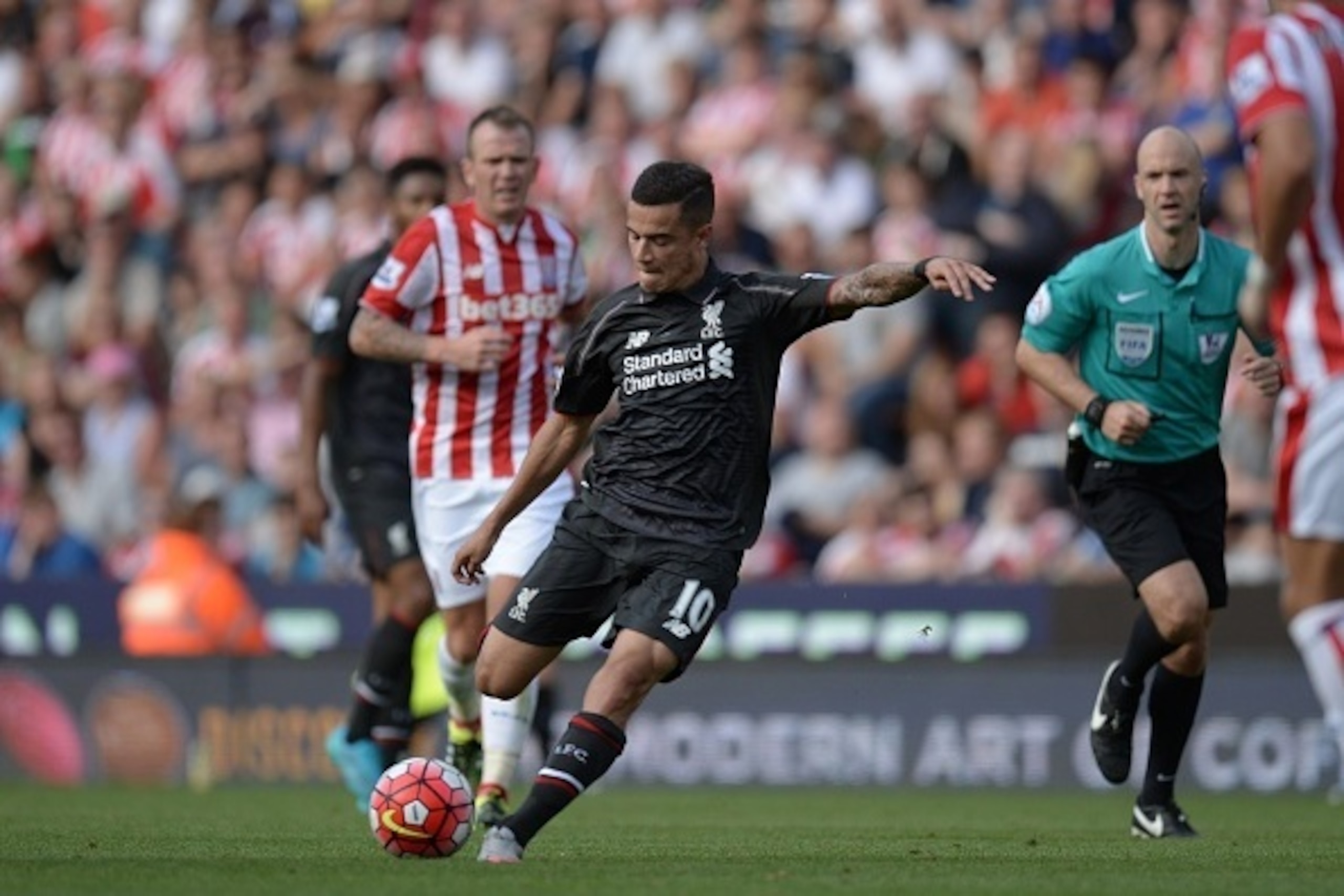 Liverpool's Brazilian midfielder Philippe Coutinho shoots to score the opening goal of the English Premier League football match between Stoke City and Liverpool at the Britannia Stadium in Stoke-on-Trent, central England on August 9, 2015. AFP PHOTO / OL Liverpool's Brazilian midfielder Philippe Coutinho shoots to score the opening goal of the English Premier League football match between Stoke City and Liverpool at the Britannia Stadium in Stoke-on-Trent, central England on August 9, 2015. AFP PHOTO / OL