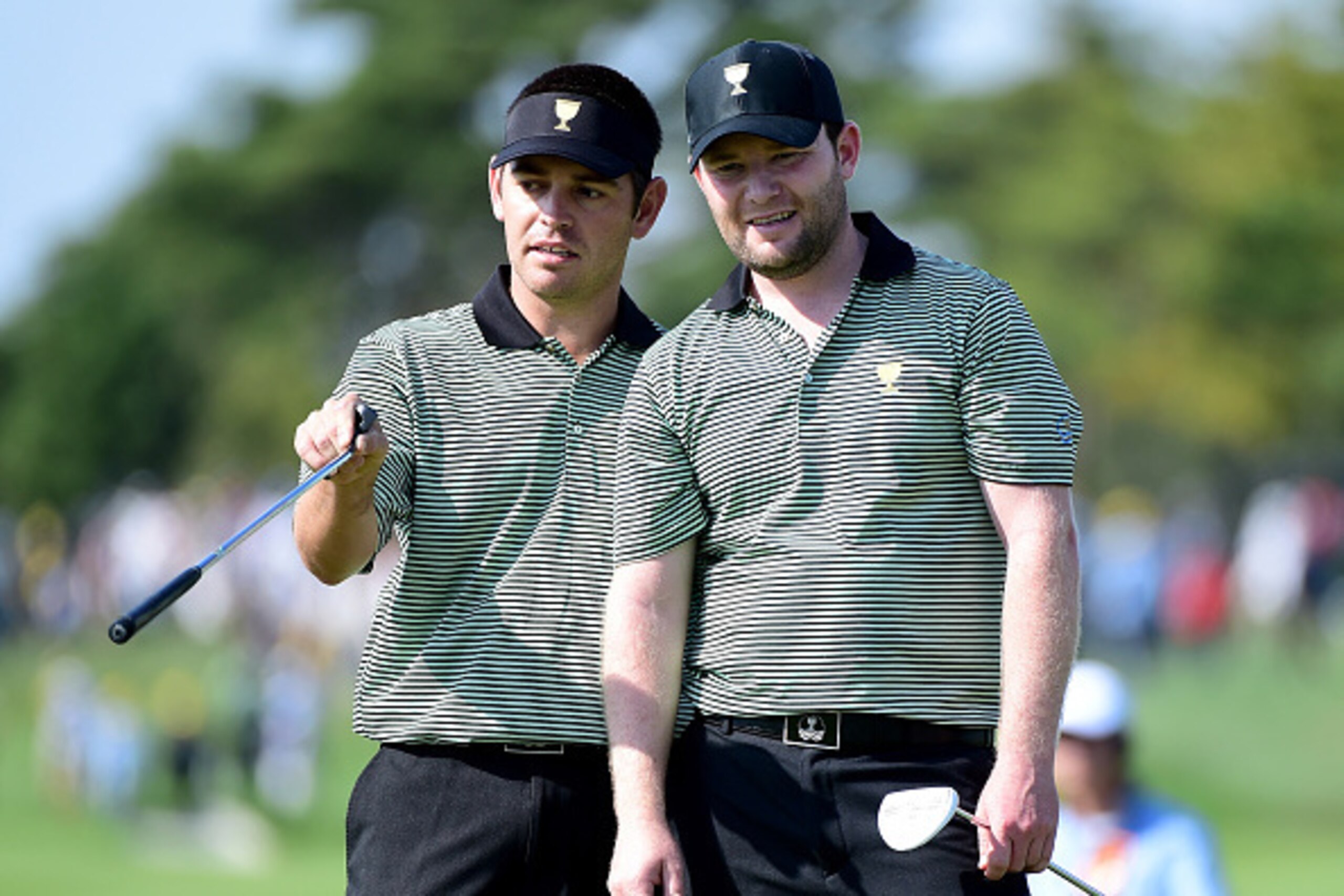 INCHEON CITY, SOUTH KOREA - OCTOBER 08:  Louis Oosthuizen and Branden Grace of the International Team line up a putt on the 14th green during the Thursday foursomes matches at The Presidents Cup at Jack Nicklaus Golf Club Korea on October 8, 2015 in Songd