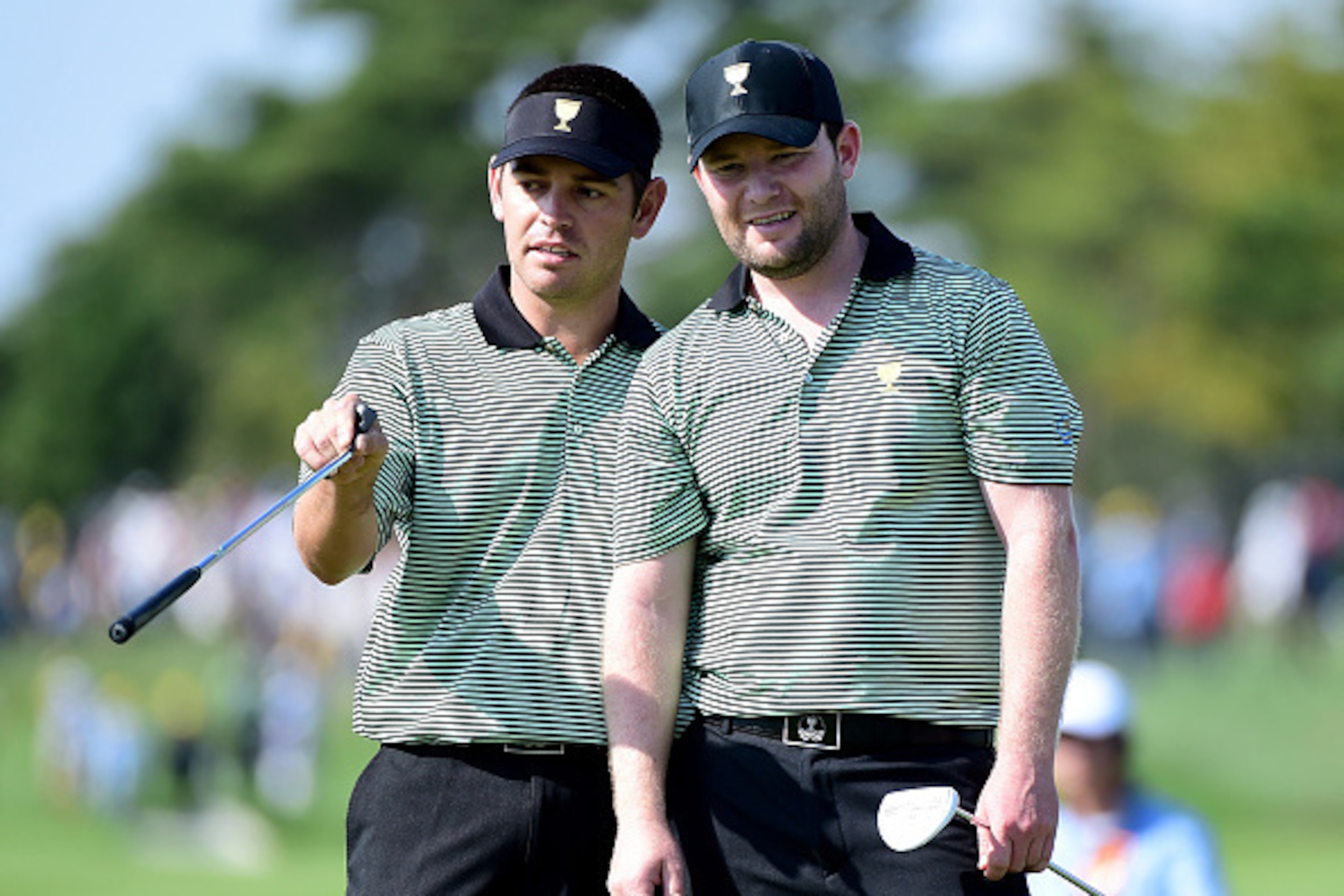 INCHEON CITY, SOUTH KOREA - OCTOBER 08:  Louis Oosthuizen and Branden Grace of the International Team line up a putt on the 14th green during the Thursday foursomes matches at The Presidents Cup at Jack Nicklaus Golf Club Korea on October 8, 2015 in Songd