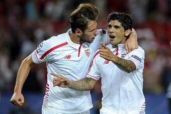 Sevilla's Argentinian midfielder Ever Banega (R) celebrates a goal with teammate Sevilla's Polish midfielder Grzegorz Krychowiak (L) during the UEFA Champions League group D football match Sevilla FC vs VfL Borussia Moenchengladbach at the Ramon Sanchez P