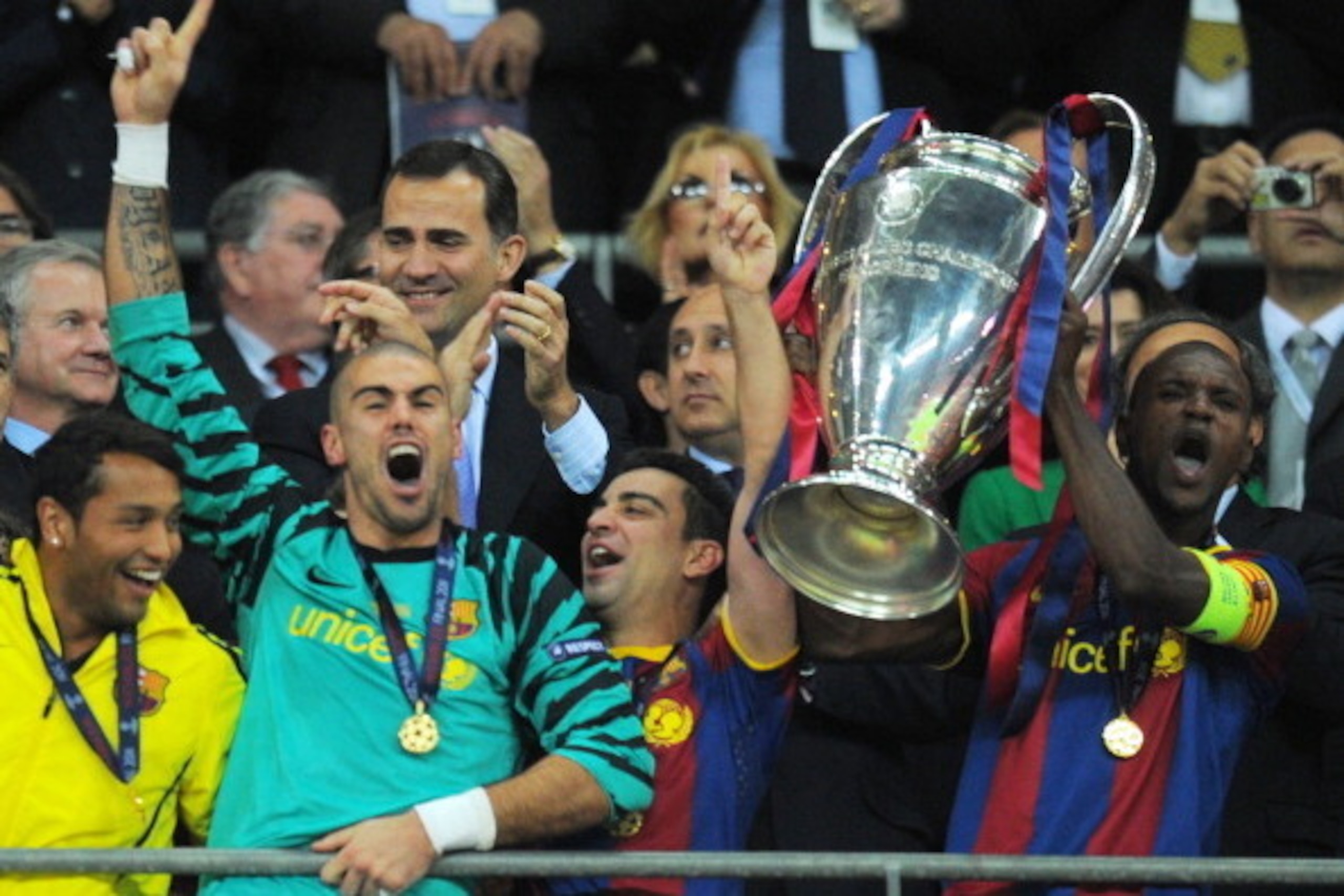 Barcelona's Spanish goalkeeper Victor Valdes (L) and Barcelona's French defender Eric Abidal (R) celebrate with the trophy at the end of the UEFA Champions League final football match FC Barcelona vs. Manchester United, on May 28, 2011 at Wembley stadium 