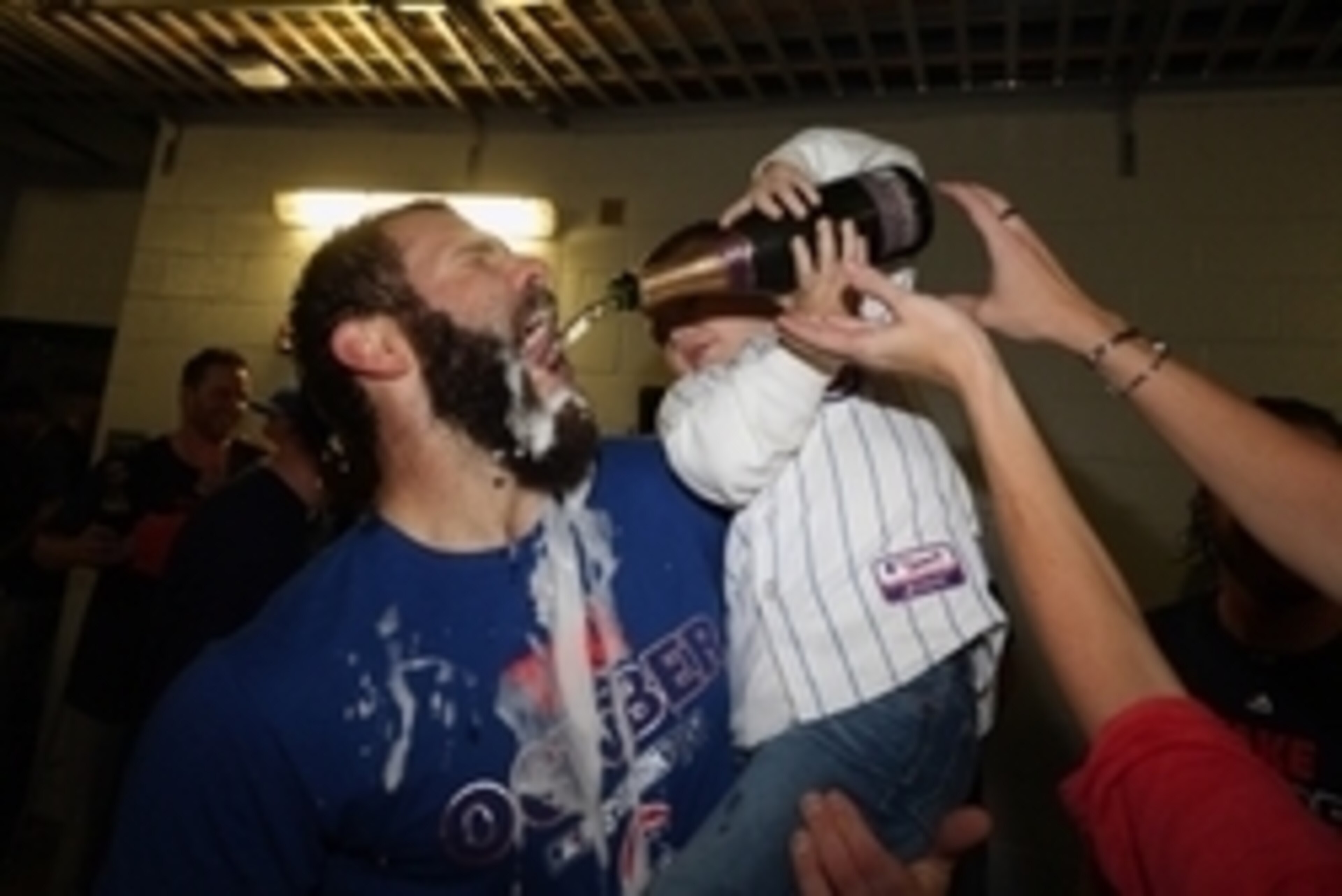 Oct 7, 2015; Pittsburgh, PA, USA; Chicago Cubs starting pitcher Jake Arrieta celebrates with his son Cooper after defeating the Pittsburgh Pirates in the National League Wild Card playoff baseball game at PNC Park. Cubs won 4-0. Mandatory Credit: Charles 