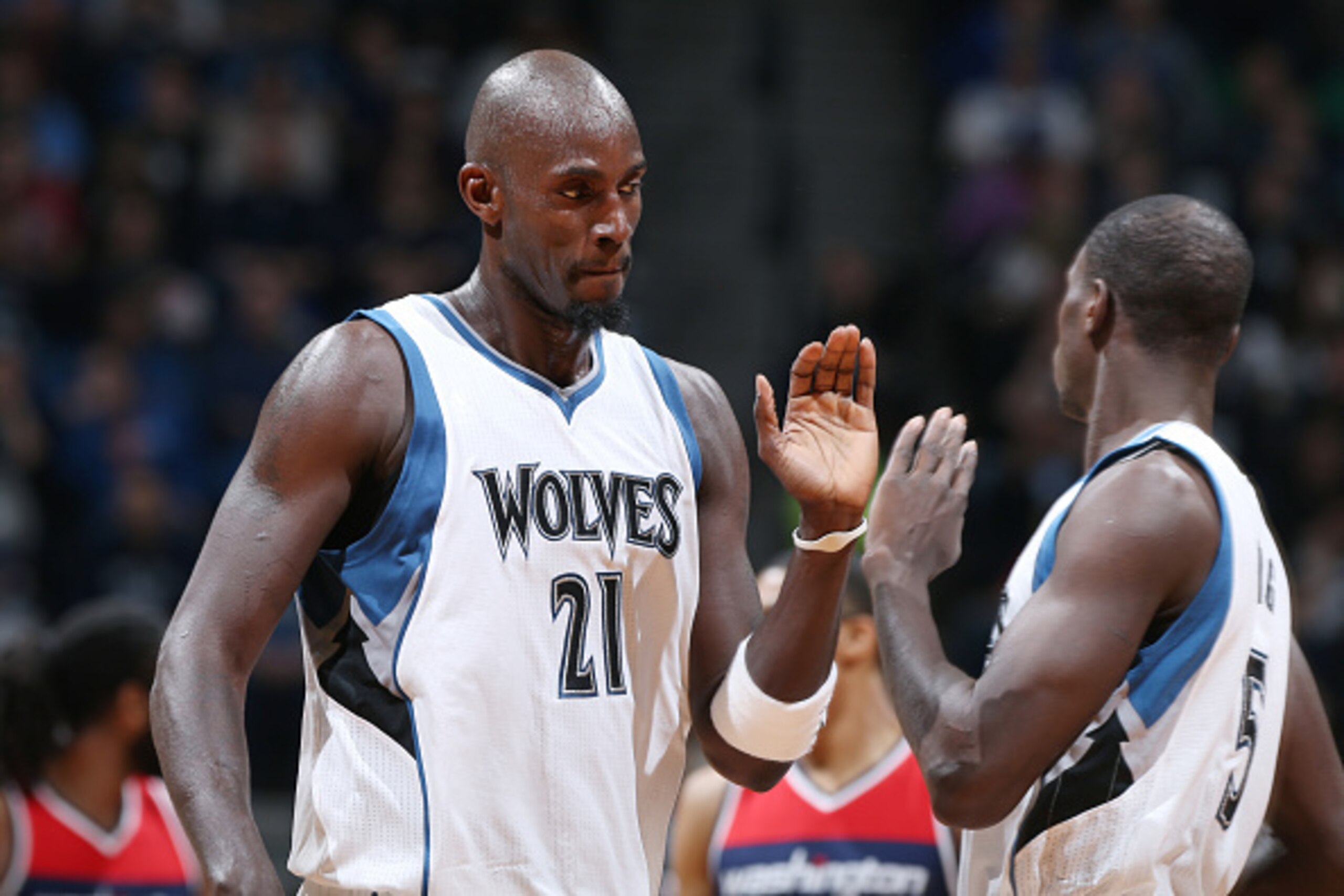 MINNEAPOLIS, MN - FEBRUARY 25: Kevin Garnett #21 high fives teammate Gorgui Dieng #5 of the Minnesota Timberwolves during the game against the Washington Wizards on February 25, 2015 at Target Center in Minneapolis, Minnesota. NOTE TO USER: User expressly