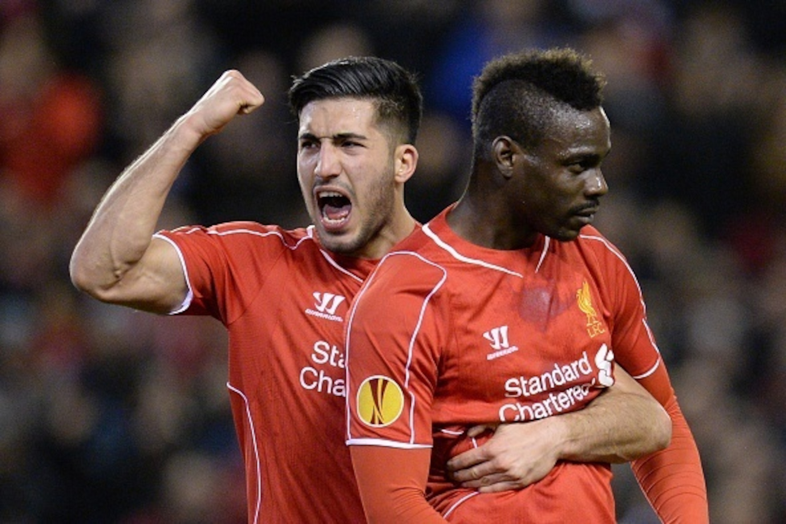 Liverpool's German midfielder Emre Can (L) celebrates with arm around Liverpool's Italian striker Mario Balotelli (R) after Balotelli scored from the penalty spot for the opening goal during the UEFA Europa League round of 32 first leg football match betw