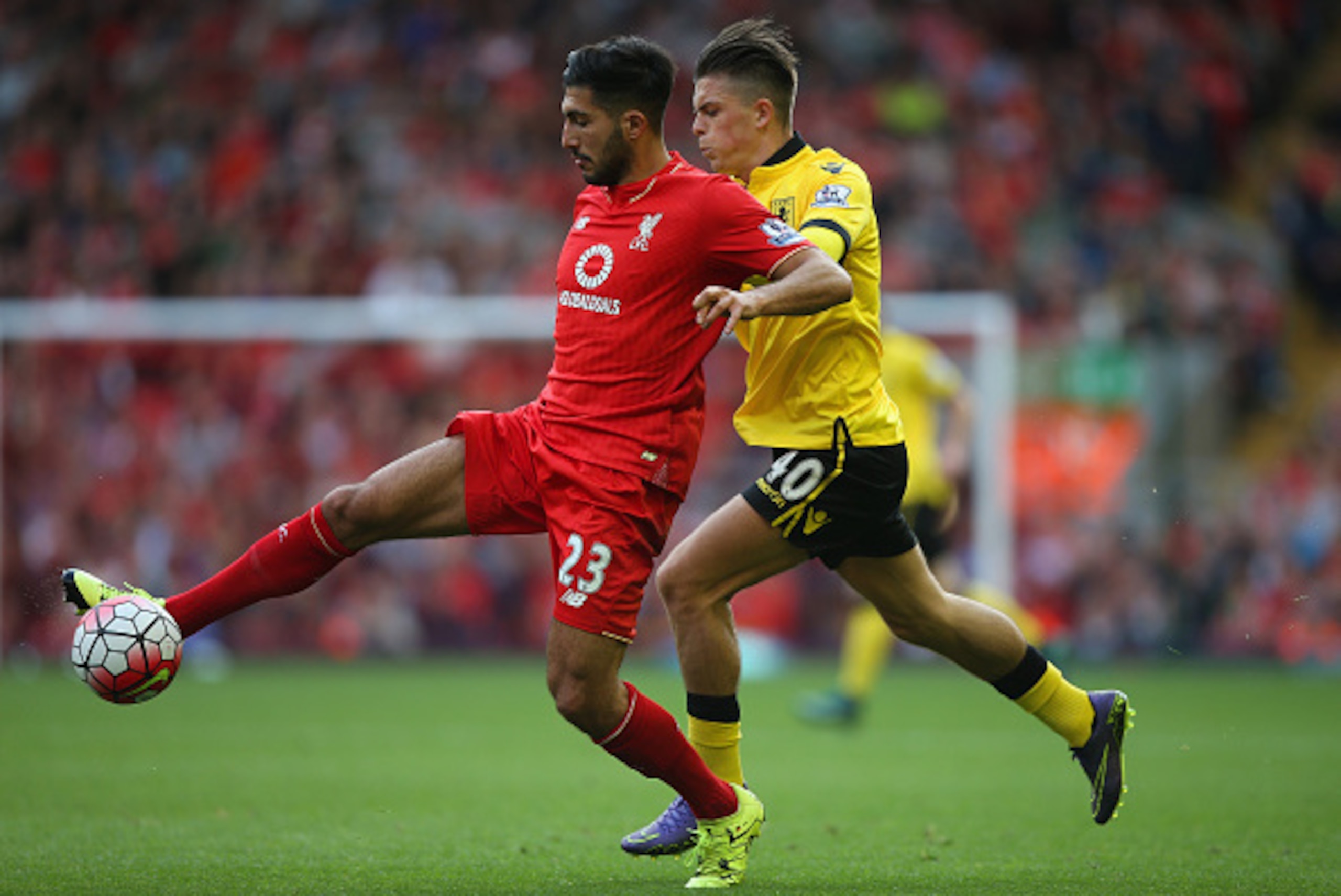LIVERPOOL, ENGLAND - SEPTEMBER 26: Emre Can of Liverpool and Jack Grealish of Aston Villa compete for the ball during the Barclays Premier League match between Liverpool and Aston Villa at Anfield on September 26, 2015 in Liverpool, United Kingdom.  (Phot
