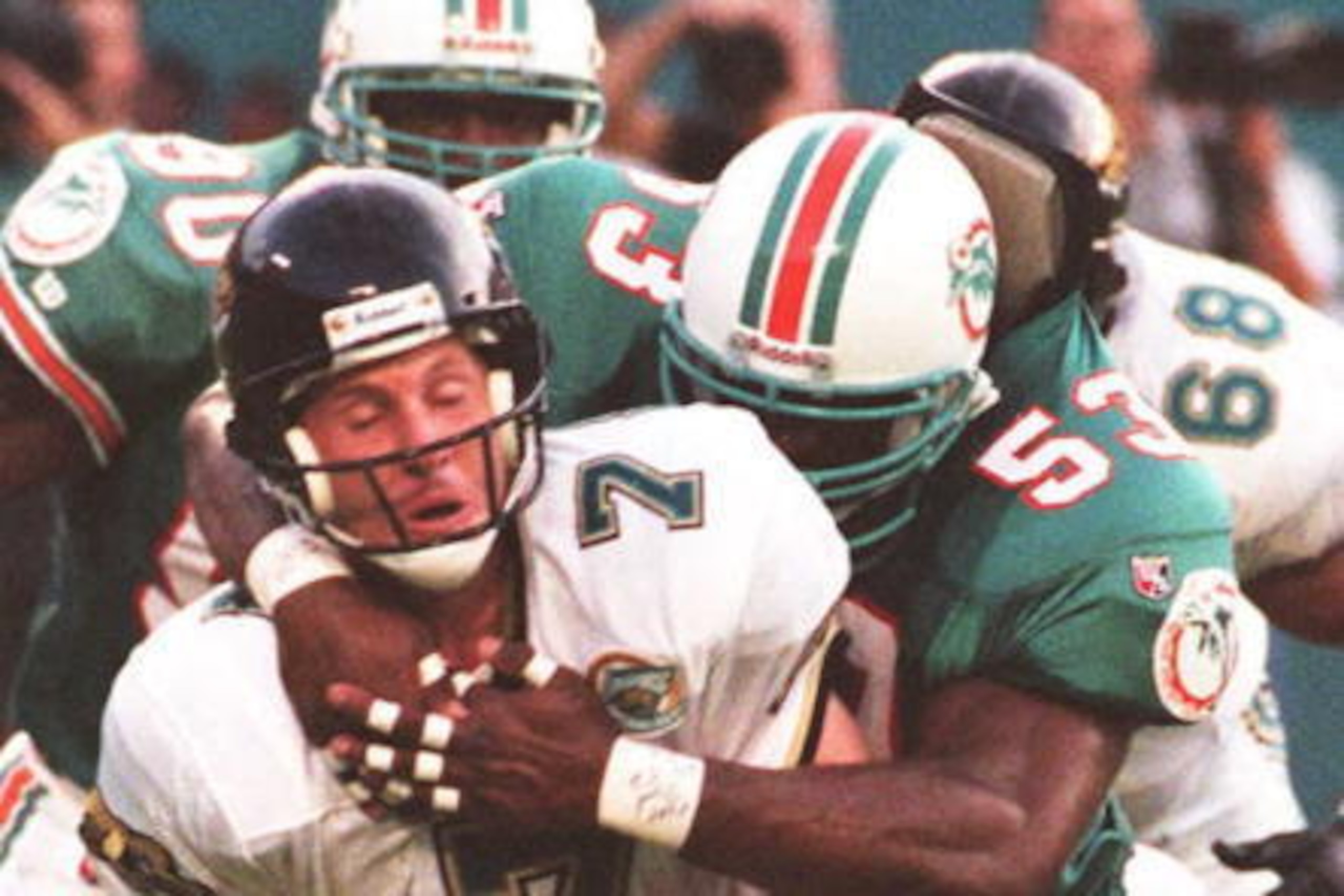 MIAMI, FL - AUGUST 4: Jacksonville Jaguars' quarterback Steve Beuerlein (L) is sacked by Miami Dolphins Aubrey Beavers 04 August during first half action of their pre-season game at Joe Robbie Stadium in Miami, FL. The Dolphins lead the Jaguars 14-7 at t MIAMI, FL - AUGUST 4: Jacksonville Jaguars' quarterback Steve Beuerlein (L) is sacked by Miami Dolphins Aubrey Beavers 04 August during first half action of their pre-season game at Joe Robbie Stadium in Miami, FL. The Dolphins lead the Jaguars 14-7 at t