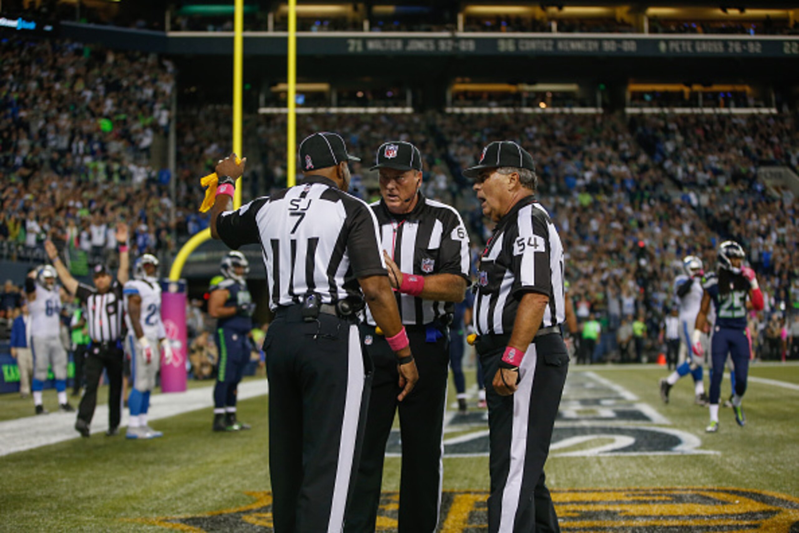 SEATTLE, WA - OCTOBER 05:  Referees confer after the ball was batted out of the end zone by outside linebacker K.J. Wright of the Seattle Seahawks following a fumble by wide receiver Calvin Johnson of the Detroit Lions in the fourth quarter at CenturyLink