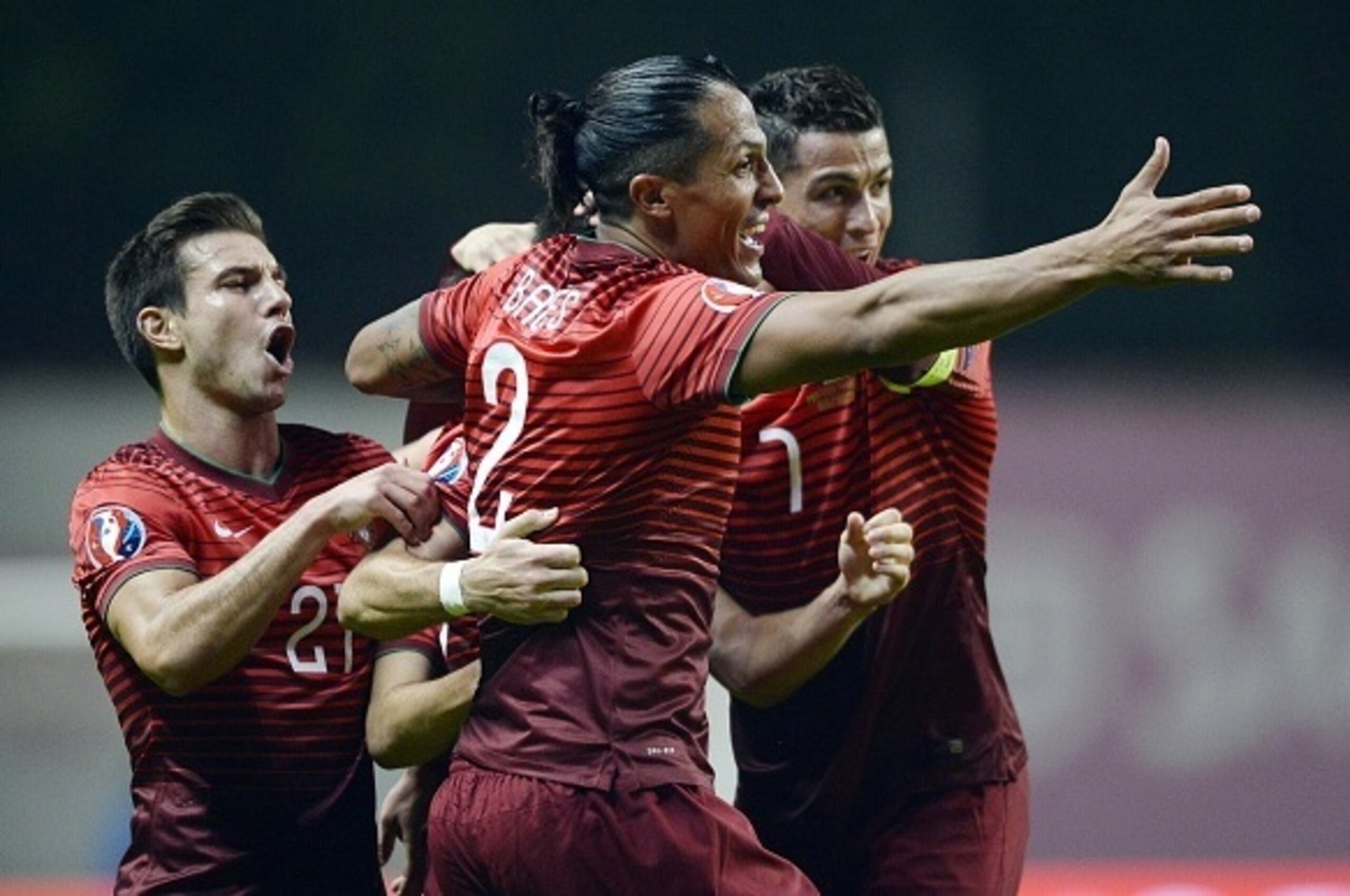 Portugal's defender Cedric Soares (L), defender Bruno Alves (C) and forward Cristiano Ronaldo (R) celebrate midfielder Joao Moutinho's goal during the Euro 2016 qualifying football match Portugal vs Denmark at the Municipal stadium in Braga on October 8, 