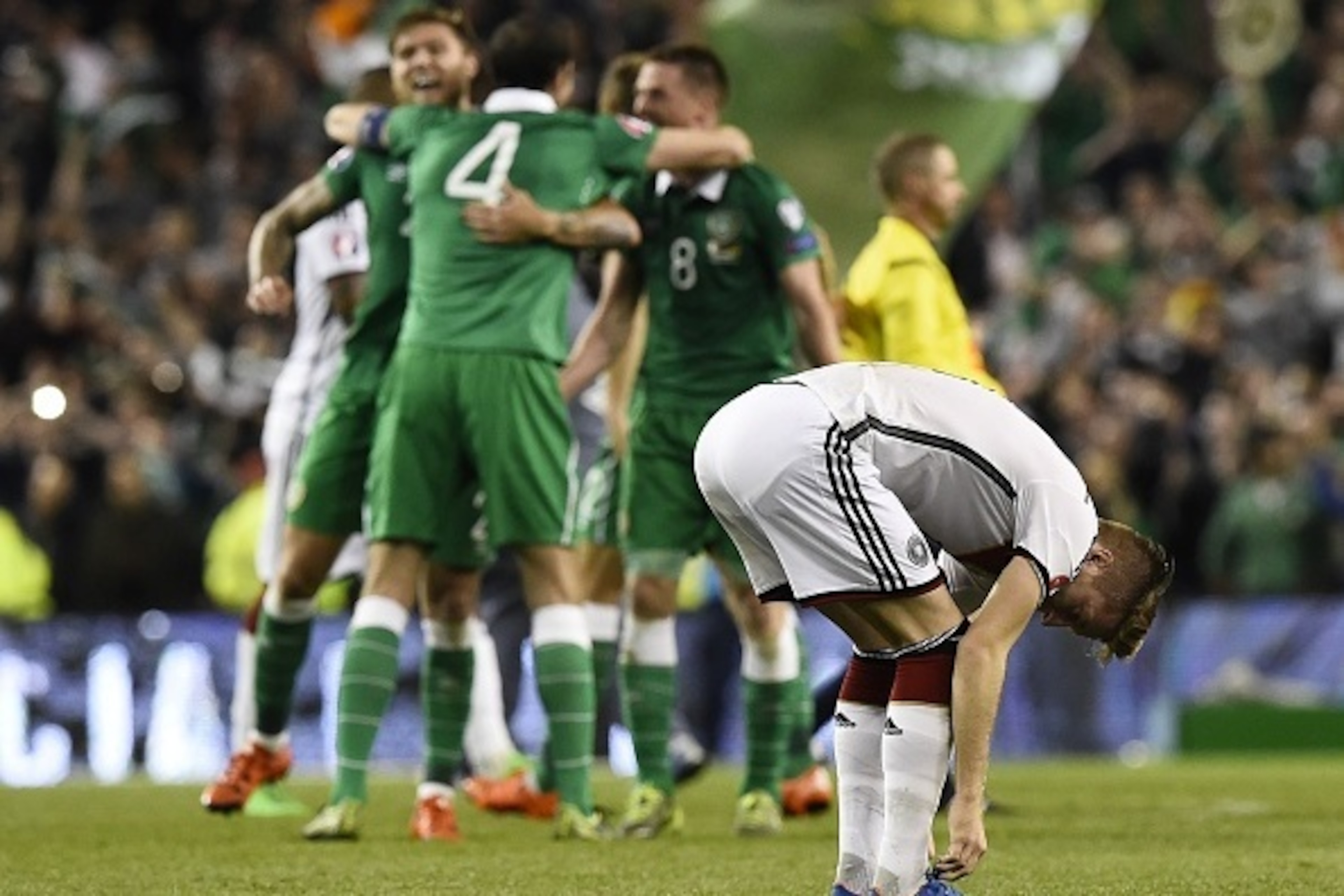 Germany's midfielder Marco Reus (R) adjusts his laces after losing a UEFA Euro 2016 Group D qualifying football match between Germany and Ireland at the Aviva stadium in Dublin on October 8, 2015. AFP PHOTO / TOBIAS SCHWARZ        (Photo credit should rea