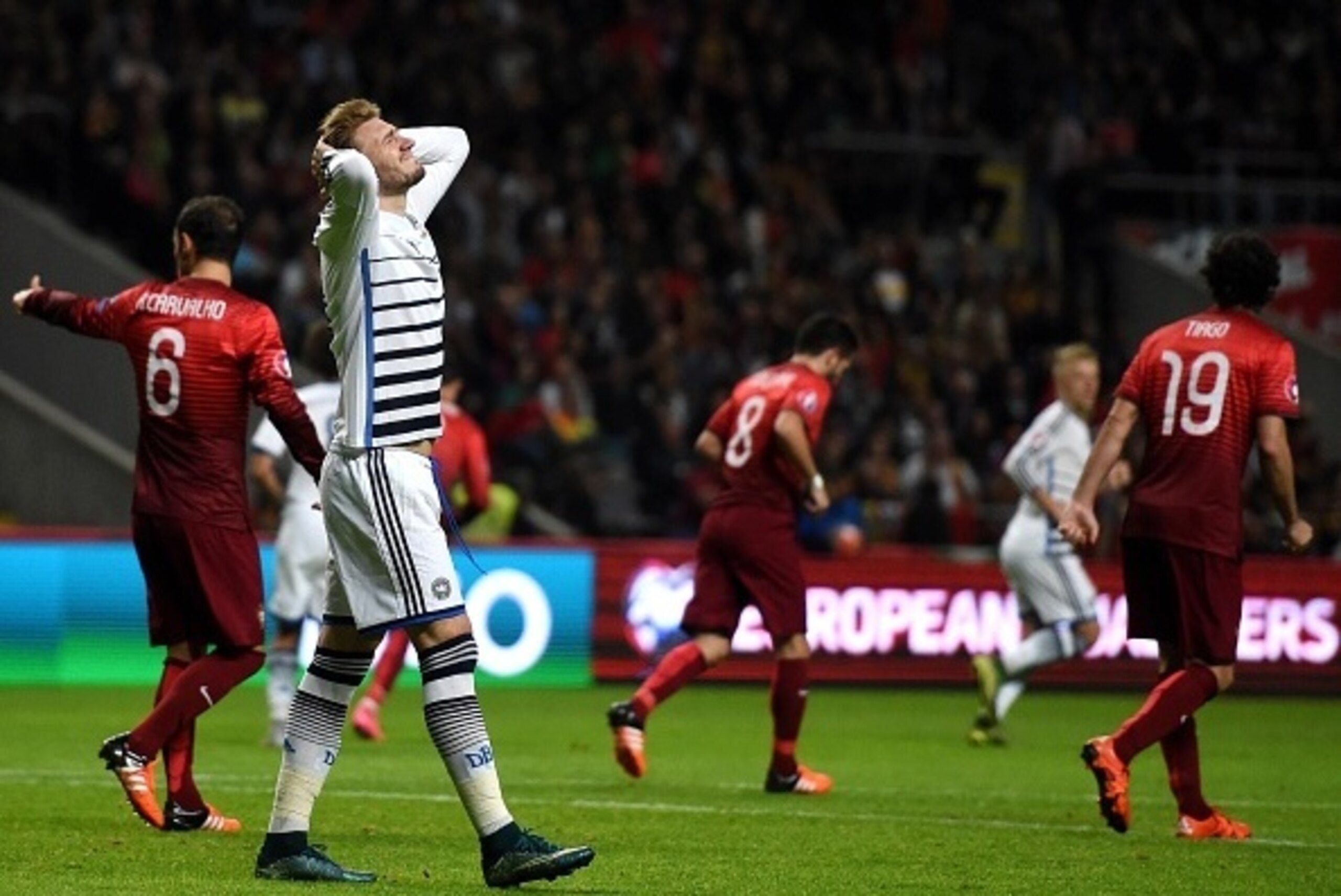 Denmark's forward Nicklas Bendtner (2nd L) gestures during the Euro 2016 qualifying football match Portugal vs Denmark at the Municipal stadium in Braga on October 8, 2015.   AFP PHOTO/ FRANCISCO LEONG        (Photo credit should read FRANCISCO LEONG/AFP/