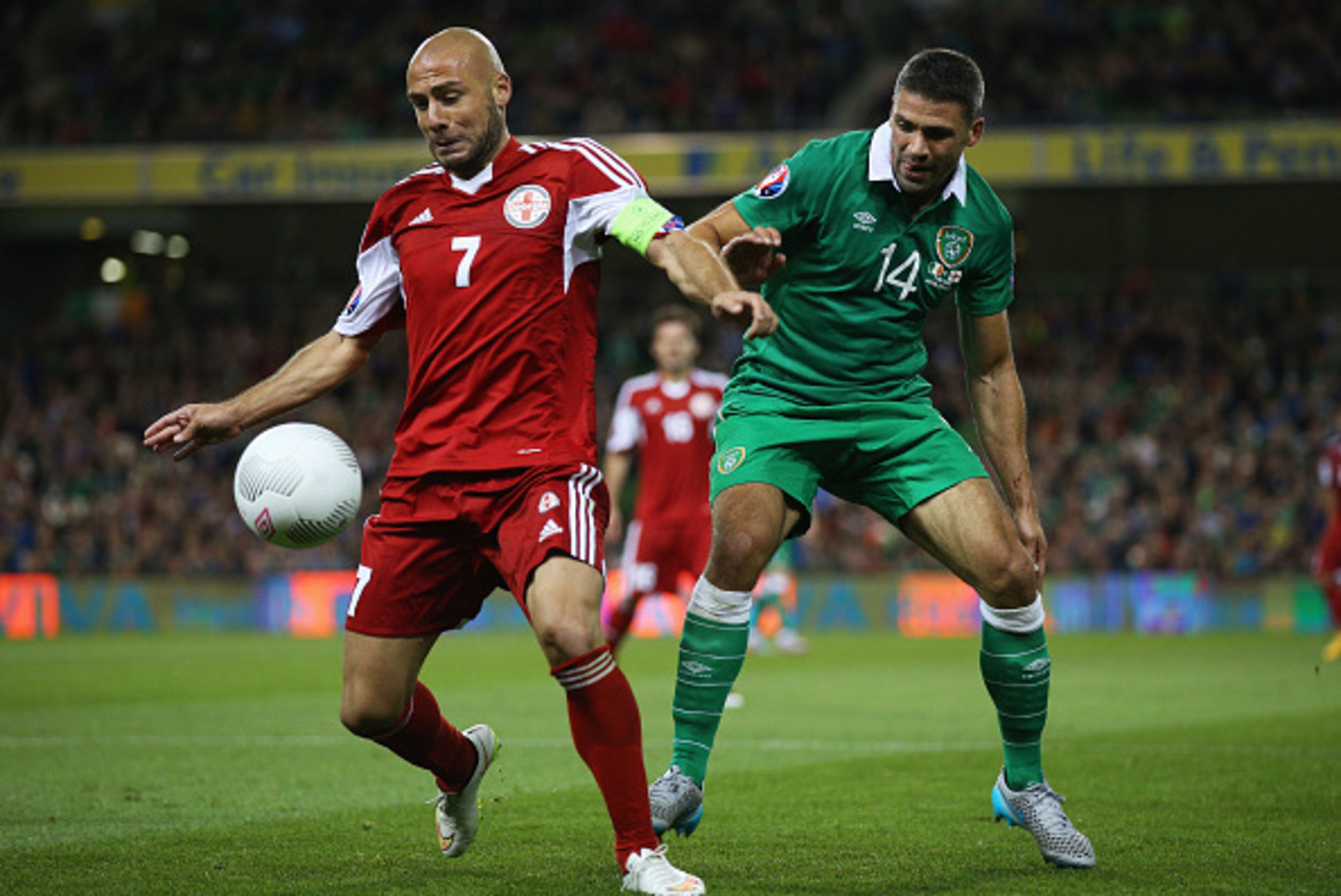 DUBLIN, IRELAND - SEPTEMBER 07: Jaba Kankava of Georgia holds off Jonathan Walters of the Republic of Ireland during the UEFA EURO 2016 Group D qualifying match between Republic of Ireland and Georgia at Aviva Stadium on September 7, 2015 in Dublin, Irel DUBLIN, IRELAND - SEPTEMBER 07: Jaba Kankava of Georgia holds off Jonathan Walters of the Republic of Ireland during the UEFA EURO 2016 Group D qualifying match between Republic of Ireland and Georgia at Aviva Stadium on September 7, 2015 in Dublin, Irel