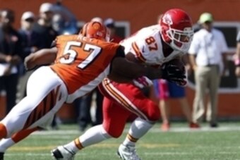 Oct 4, 2015; Cincinnati, OH, USA; Cincinnati Bengals linebacker Vincent Rey (57) tackles Kansas City Chiefs tight end Travis Kelce (87) in the second half at Paul Brown Stadium. Cincinnati defeated Kansas City 36-21. Mandatory Credit: Mark Zerof-USA TODAY