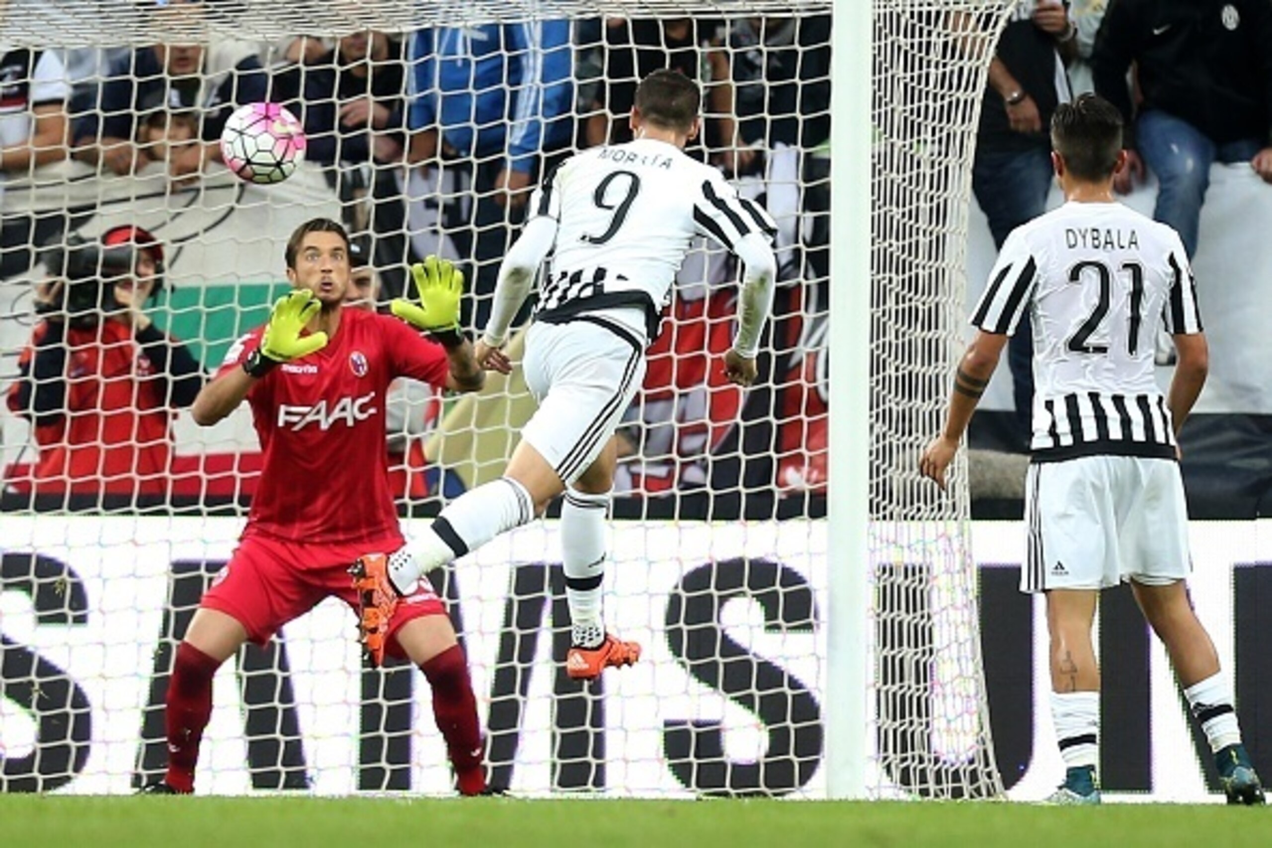 Juventus' forward Alvaro Morata from Spain (C) scores during the Italian Serie A  football match Juventus Vs Bologna on October 4, 2015 at the 'Juventus Stadium' in Turin.  AFP PHOTO / MARCO BERTORELLO        (Photo credit should read MARCO BERTORELLO/AFP