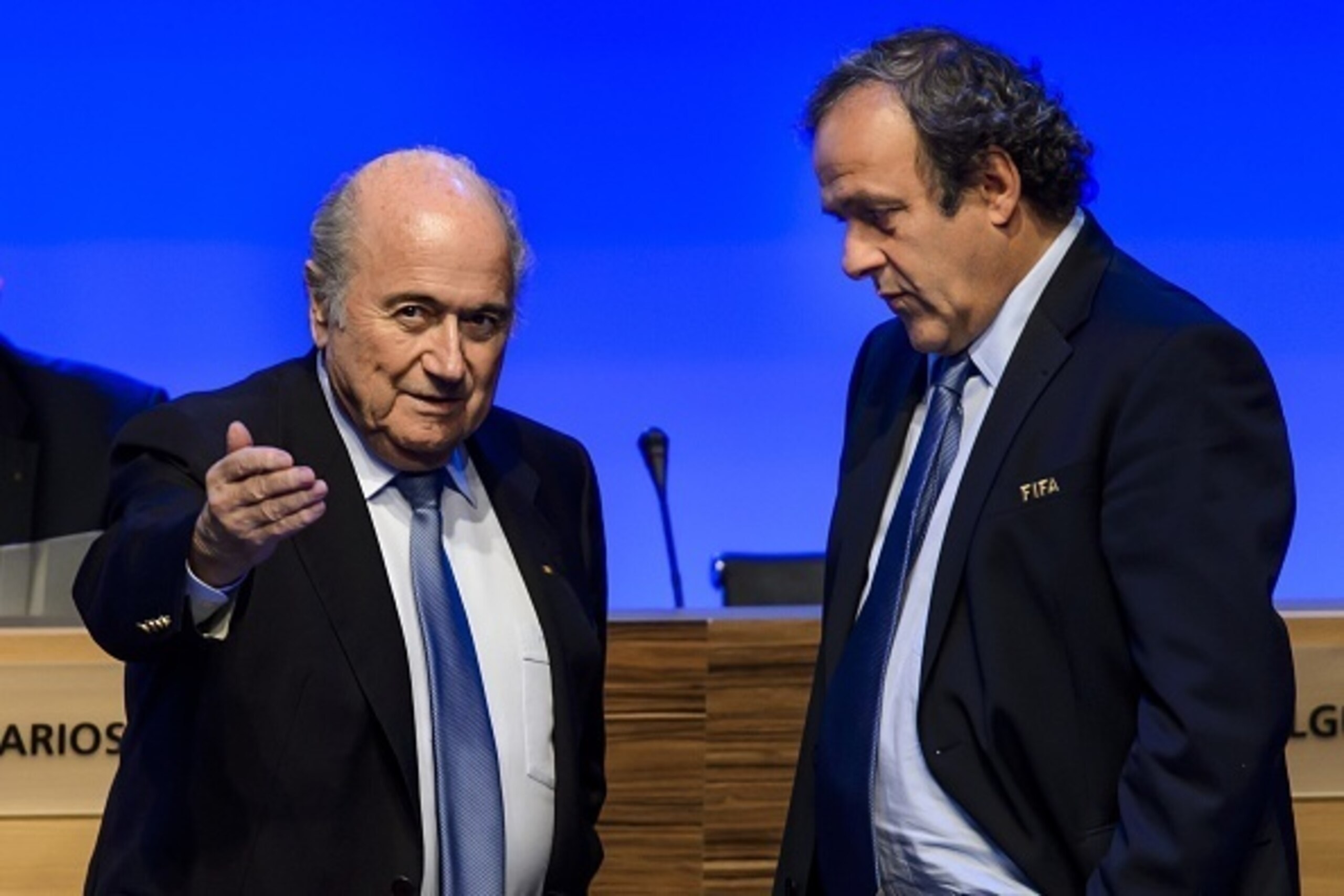 FIFA president Joseph Blatter (L) talks to UEFA president Michel Platini during the 64th FIFA congress on June 11, 2014 in Sao Paulo, on the eve of the opening match of the 2014 FIFA World Cup in Brazil.     AFP PHOTO / FABRICE COFFRINI        (Photo cred