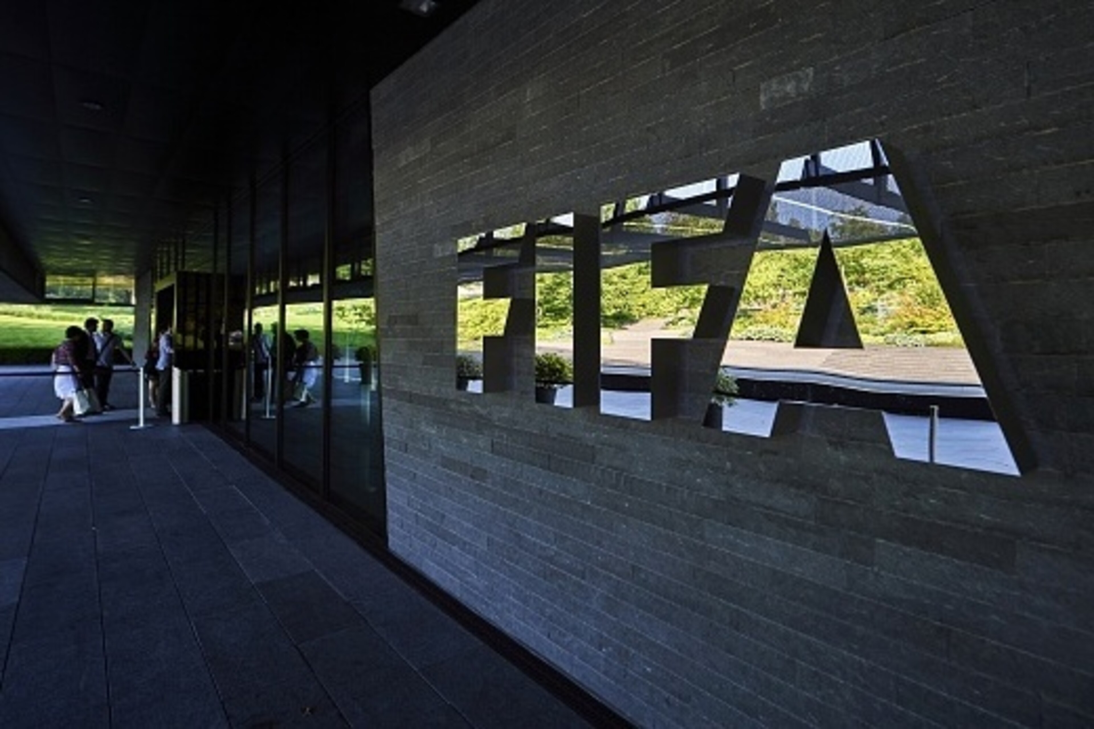 FIFA employees enter at the FIFA headquarters on June 3, 2015 in Zurich. Blatter resigned on June 2, 2015 as president of FIFA as a mounting corruption scandal engulfed world football's governing body. The 79-year-old Swiss official, FIFA president for 17