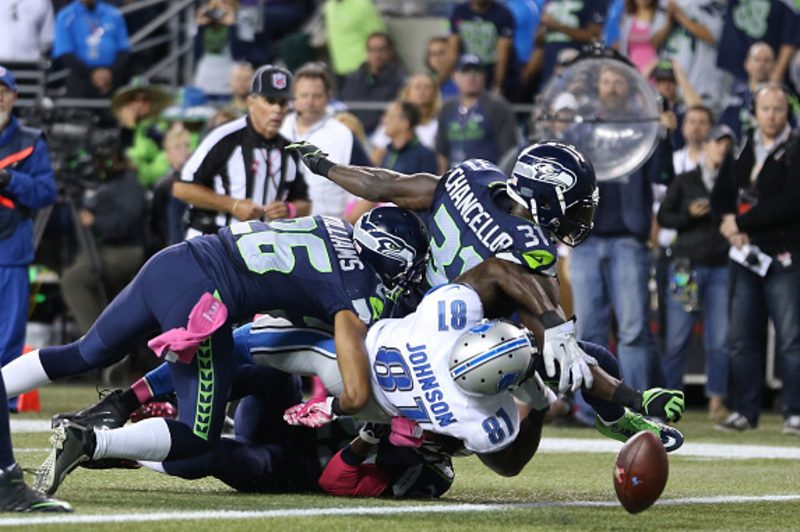 SEATTLE, WA - OCTOBER 5: Defensive back Kam Chancellor #31 of the Seattle Seahawks knocks the ball out of the hands of wide receiver Calvin Johnson #81 of the Detroit Lions near the goal ling during the fourth quarter of the football game at CenturyLink F