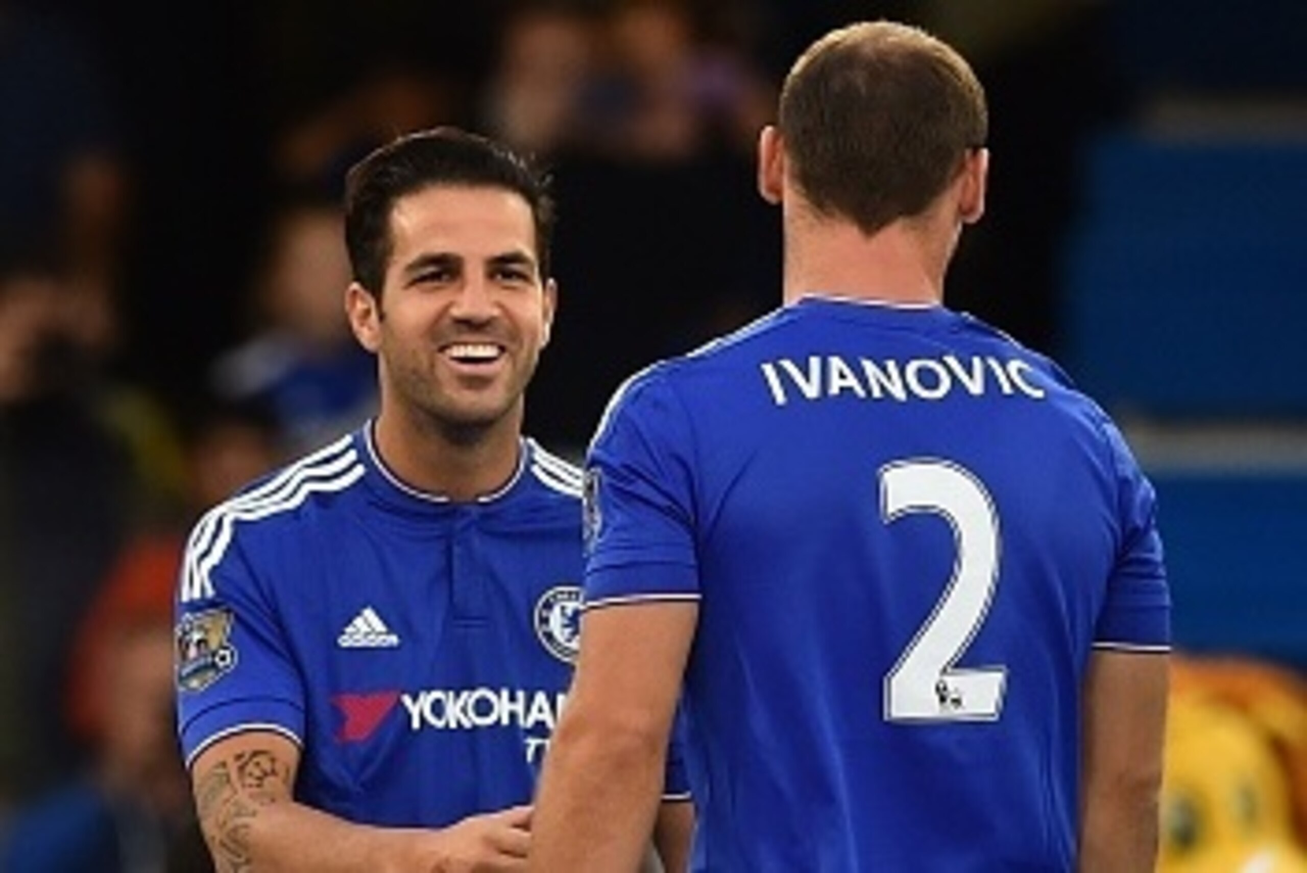 Chelsea's Spanish midfielder Cesc Fabregas (L) greets Chelsea's Serbian defender Branislav Ivanovic (R) during a welcome for the players before the start of the pre-season friendly football match between Chelsea and Fiorentina at Stamford Bridge in London