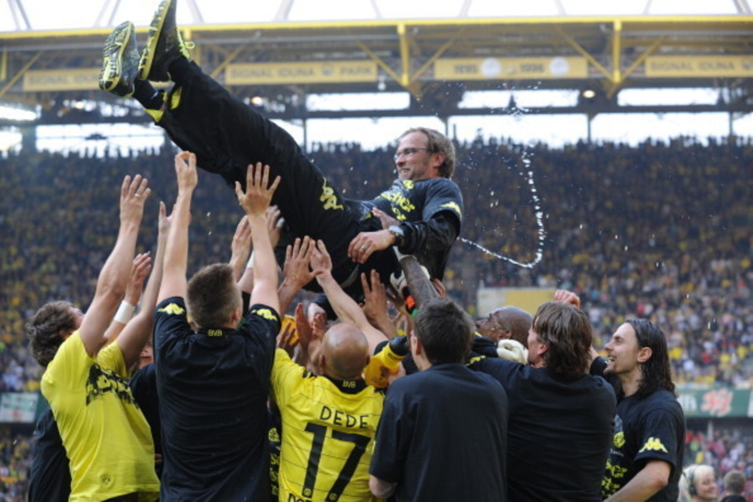 DORTMUND, GERMANY - APRIL 30:Dortmund playsers toss Jurgen Klopp, a coach of Dortmund, into the air as they win German Bundes Liga title at Signal Iduna Park on April 30, 2011 in Dortmund, Germany.  (Photo by Kaz Photography/Getty Images)