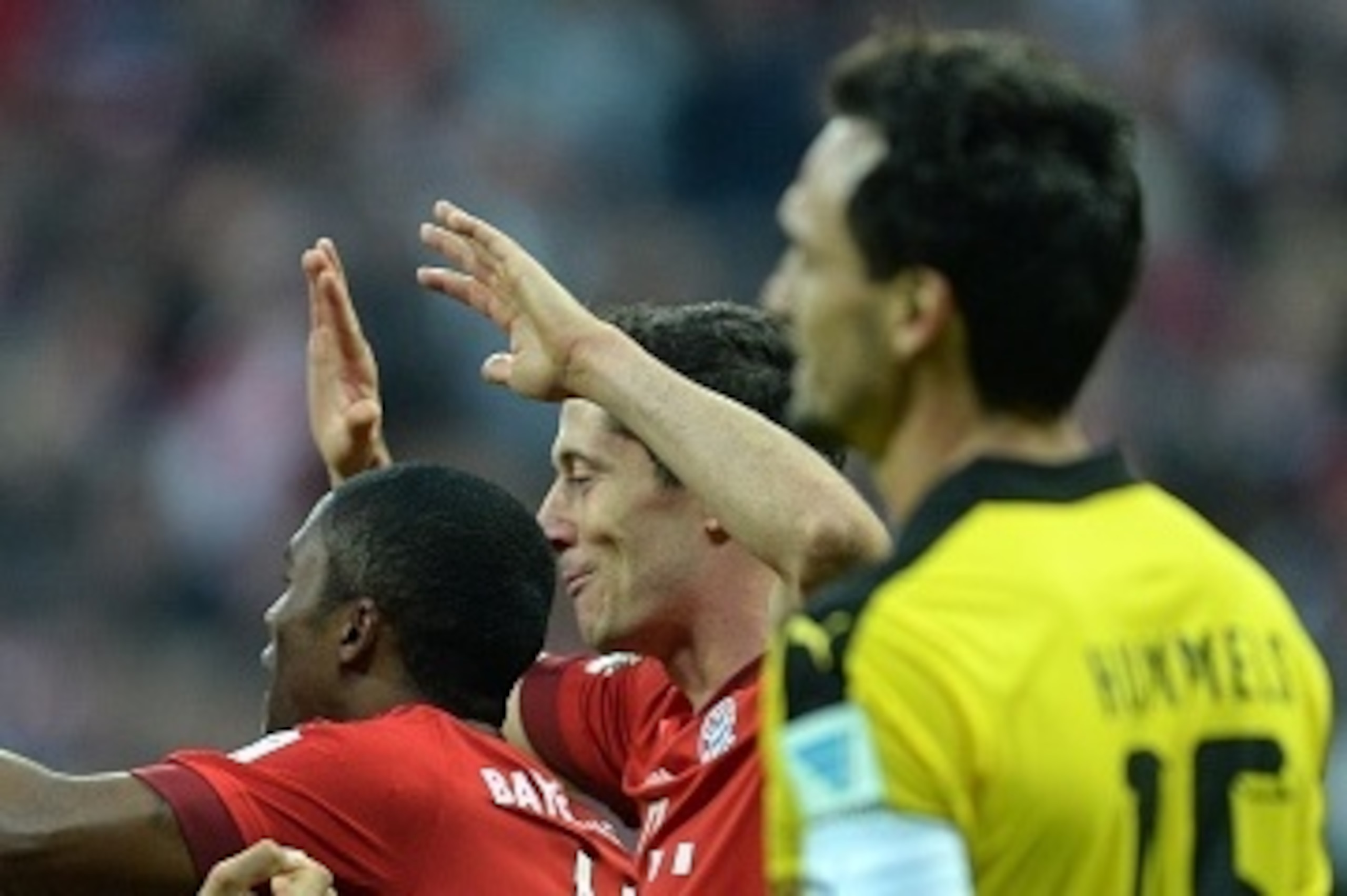 (L-R) Bayern Munich's striker Thomas Mueller, Bayern Munich's midfielder Mario Goetze, FC Bayern Munich's Brazilian midfielder Douglas Costa and FC Bayern Munich's Polish striker Robert Lewandowski celebrate after the third goal for Munich beside of Dortm