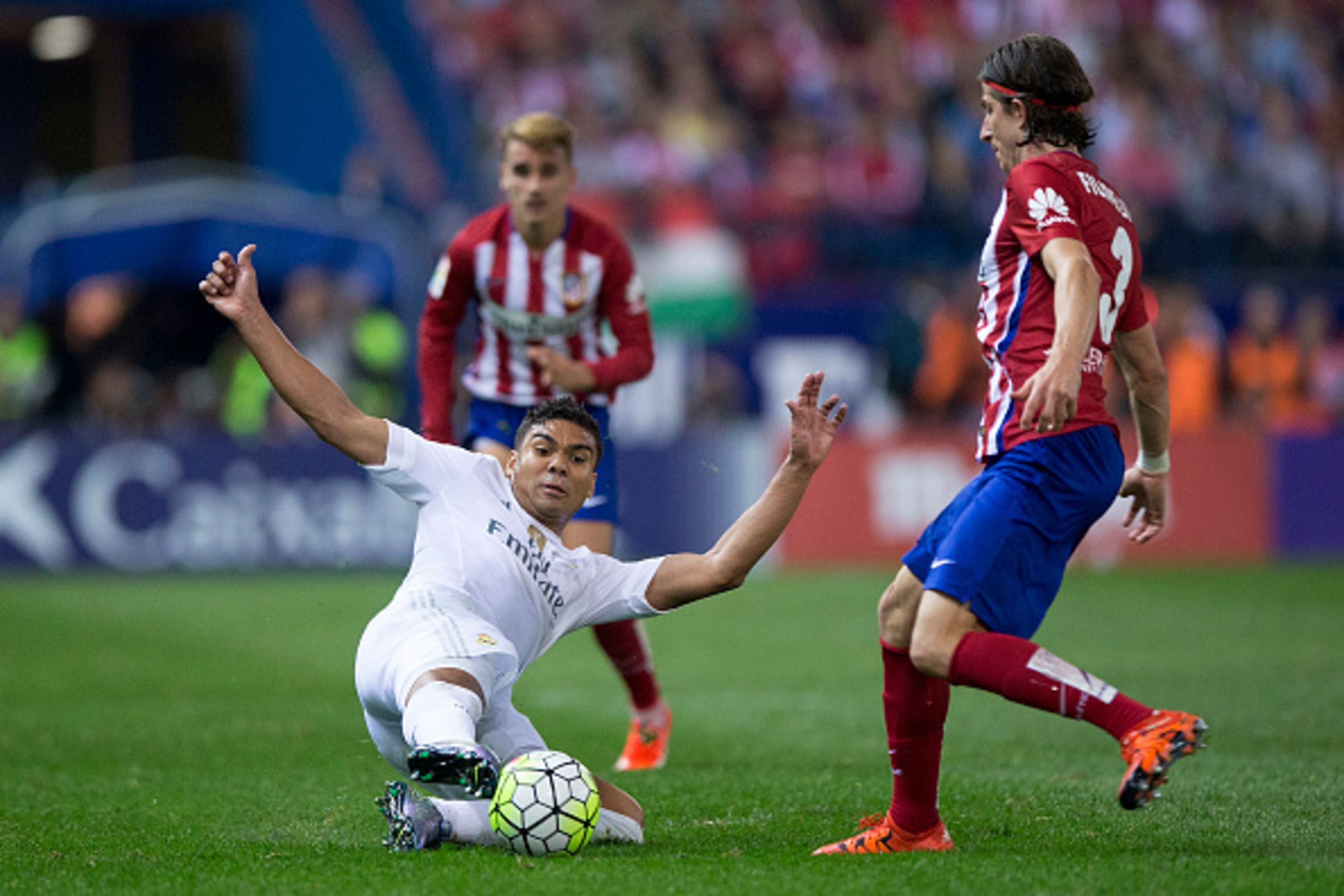 MADRID, SPAIN - OCTOBER 04: Carlos Casemiro (L) of Real Madrid CF competes for the ball with Filipe Luis (R) of Atletico de Madrid during the La Liga match between Club Atletico de Madrid and Real Madrid CF at Vicente Calderon Stadium on October 4, 2015 i