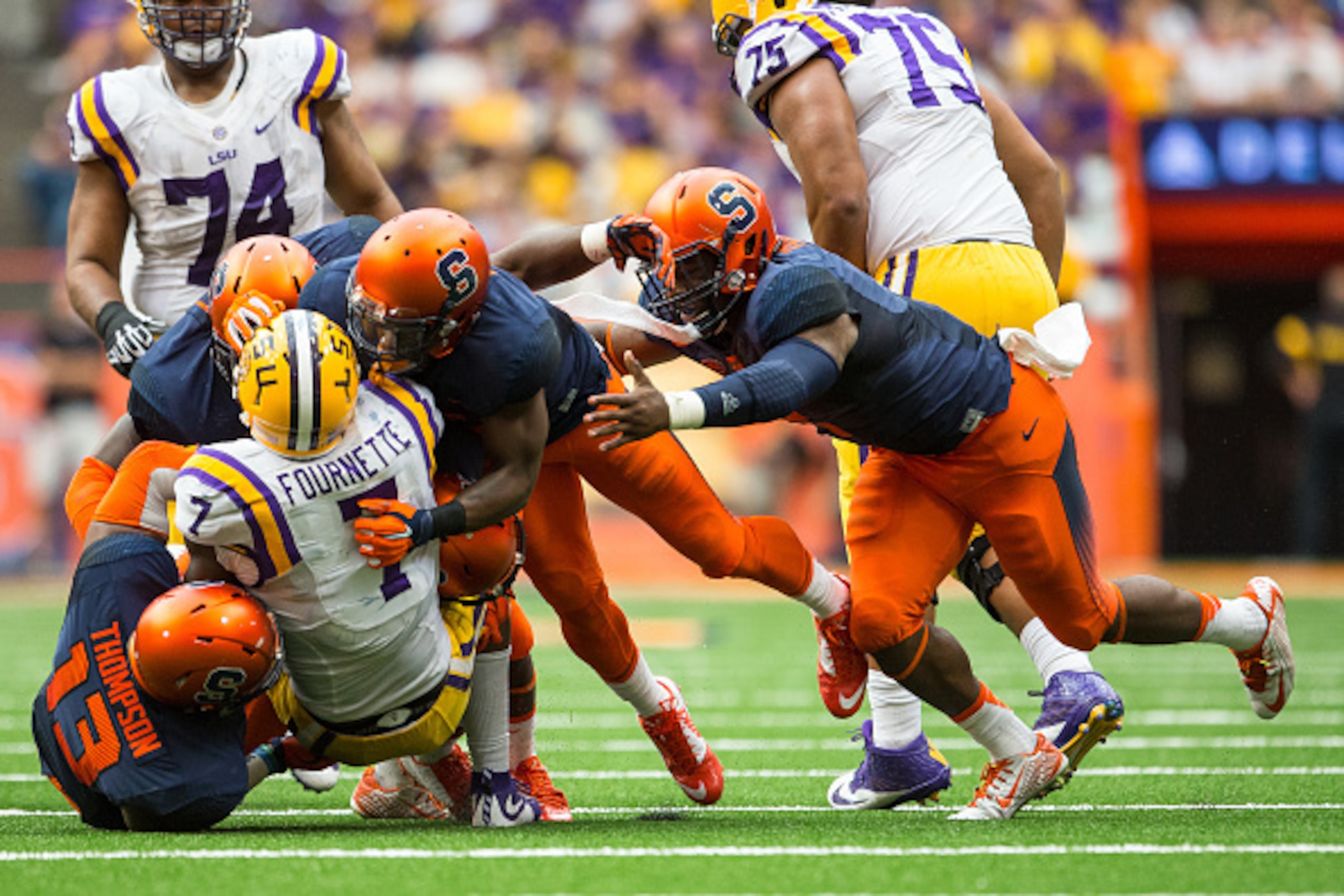 SYRACUSE, NY - SEPTEMBER 26:  Leonard Fournette #7 of the LSU Tigers is stopped by a group of Syracuse Orange players during the second half on September 26, 2015 at The Carrier Dome in Syracuse, New York.  LSU defeats Syracuse 34-24.  (Photo by Brett Car