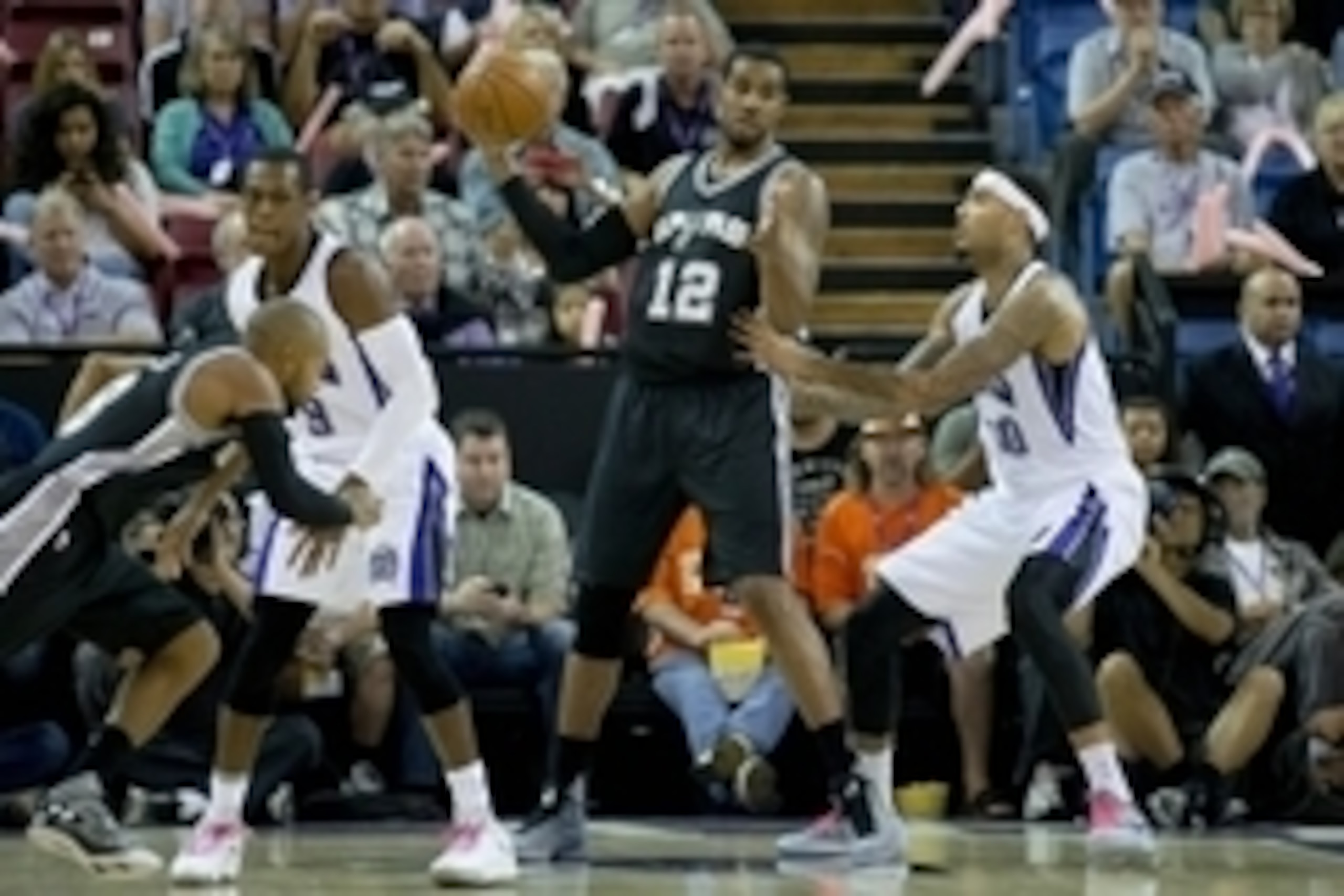 Oct 8, 2015; Sacramento, CA, USA; San Antonio Spurs forward LaMarcus Aldridge (12) dribbles the ball as Sacramento Kings center Willie Cauley-Stein (00) defends during the first quarter at Sleep Train Arena. Mandatory Credit: Kelley L Cox-USA TODAY Sports