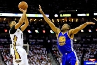 Apr 25, 2015; New Orleans, LA, USA; New Orleans Pelicans guard Eric Gordon (10) shoots over Golden State Warriors guard Andre Iguodala (9) during the second half in game four of the first round of the NBA Playoffs at the Smoothie King Center. The Warriors