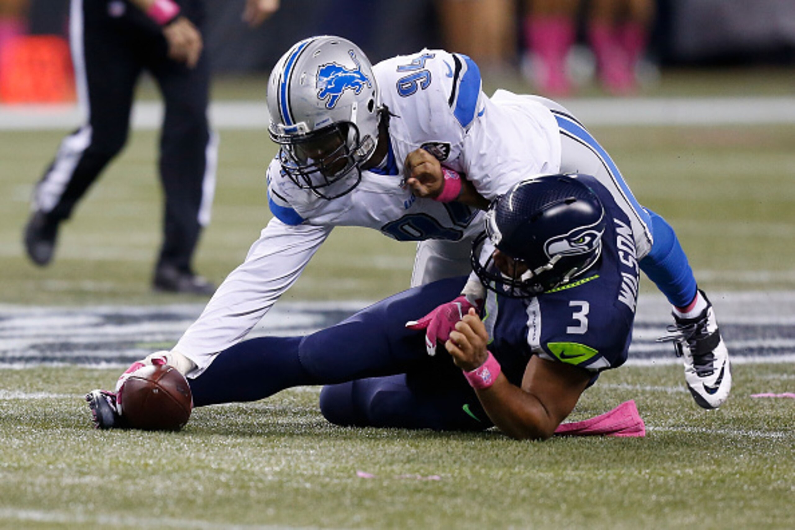 SEATTLE, WA - OCTOBER 05:  Ezekiel Ansah #94 of the Detroit Lions forces and recovers a fumble by Russell Wilson #3 of the Seattle Seahawks during the fourth quarter of their game at CenturyLink Field on October 5, 2015 in Seattle, Washington.  (Photo by 