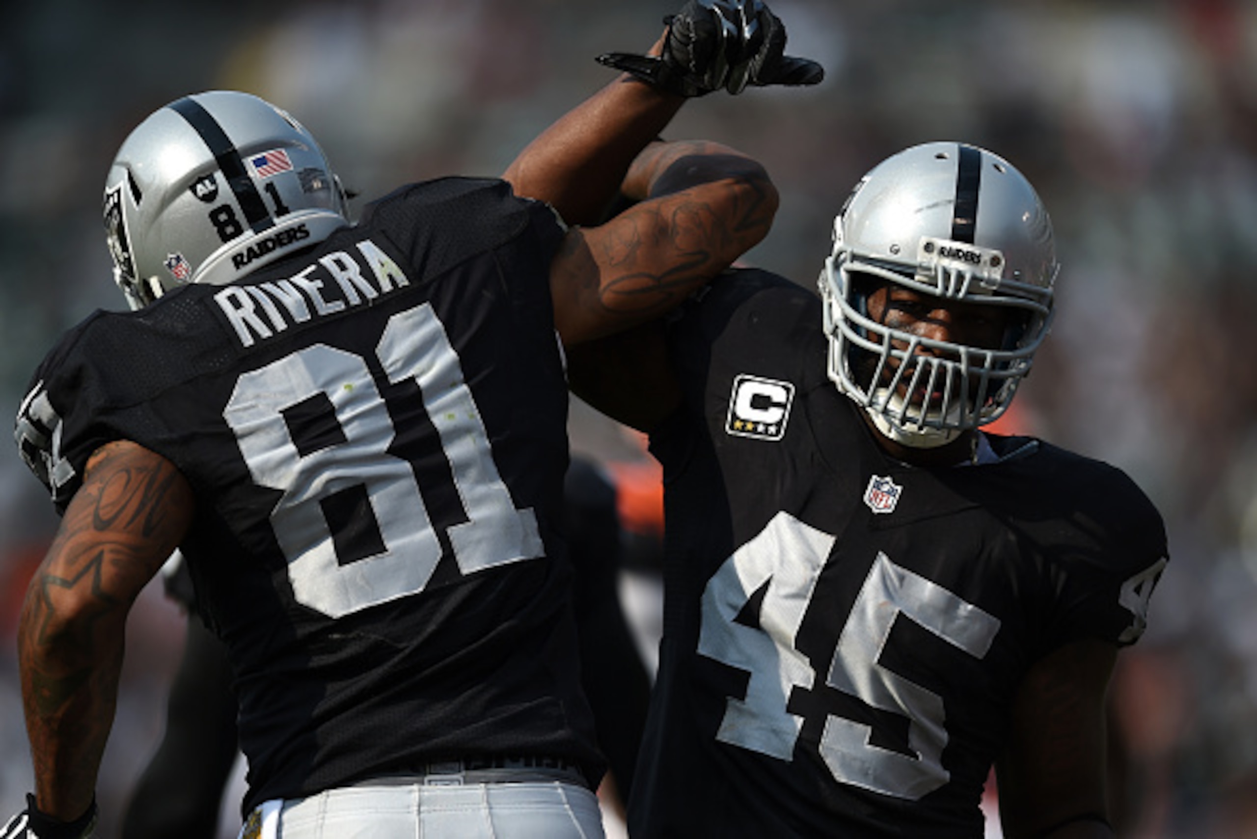 OAKLAND, CA - SEPTEMBER 13:  Marcel Reece #45 of the Oakland Raiders celebrates his second touchdown with Mychal Rivera #81 in the second half of their NFL game at O.co Coliseum on September 13, 2015 in Oakland, California.  (Photo by Thearon W. Henderson