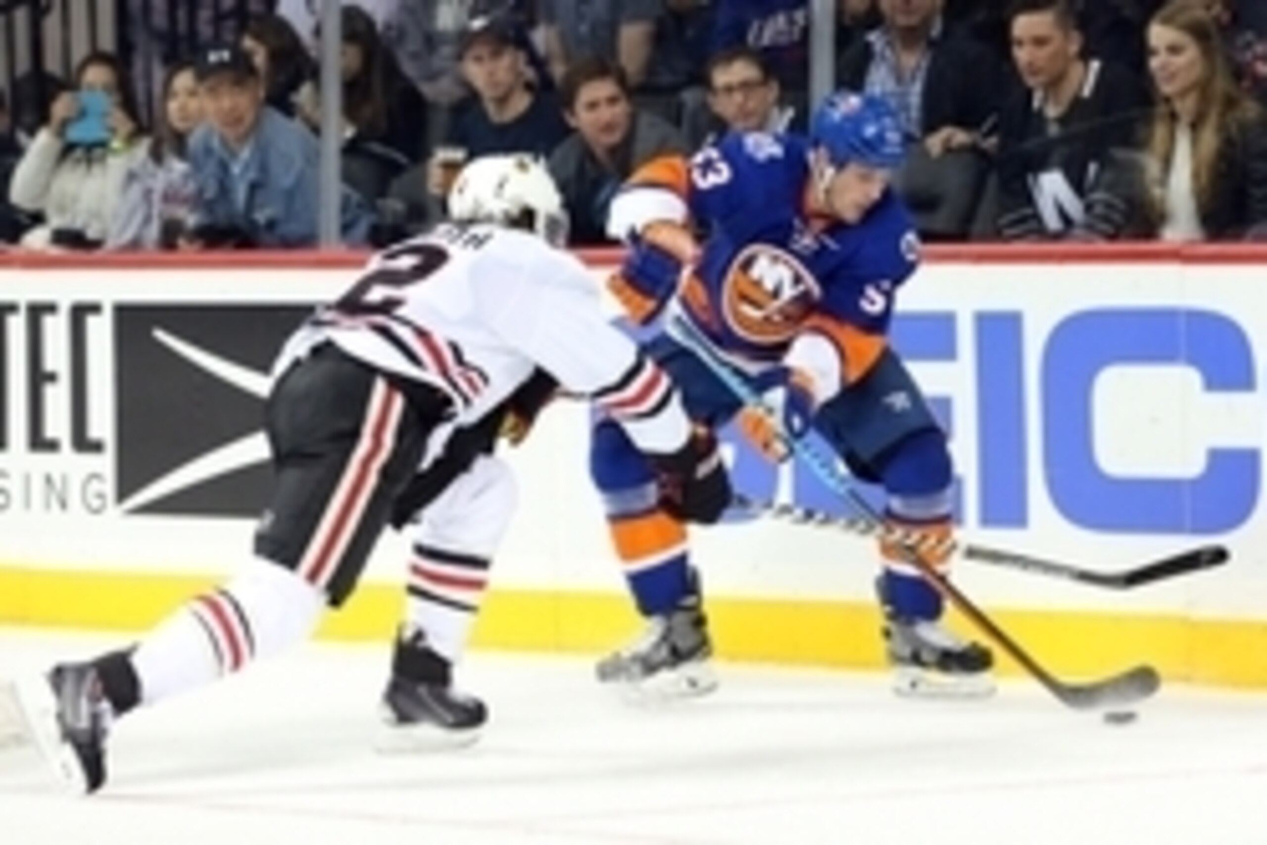 Oct 9, 2015; Brooklyn, NY, USA; New York Islanders center Casey Cizikas (53) plays the puck against Chicago Blackhawks defenseman Duncan Keith (2) during the second period at Barclays Center. Mandatory Credit: Brad Penner-USA TODAY Sports
