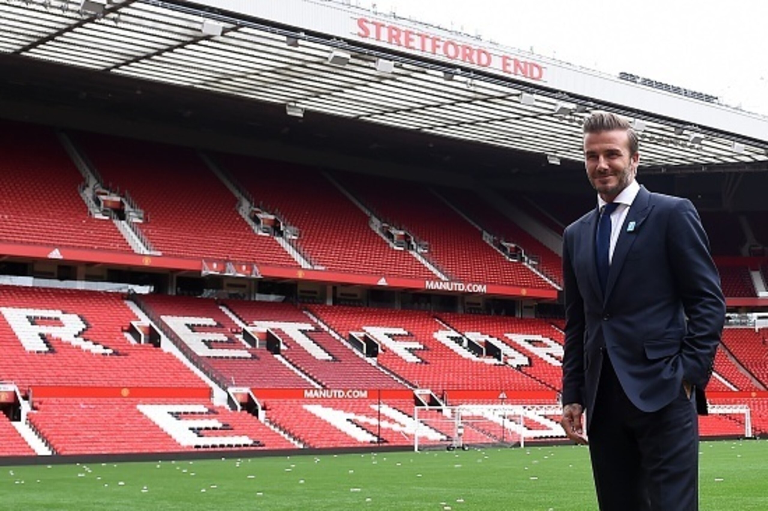 Former Manchester United and England footballer David Beckham poses on the pitch at Old Trafford in Manchester, north west England on October 6, 2015 ahead of a charity football match in aid of UNICEF. Beckham will lead the Great Britain and Ireland team 