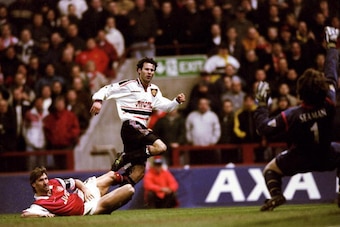 14 Apr 1999:  Ryan Giggs of Manchester United beats the despairing lunge of Tony Adams of Arsenal to drive the ball past David Seaman to score the winner in the FA Cup Semi Final match played at Villa Park in Birmingham. Manchester United won the game 2-1