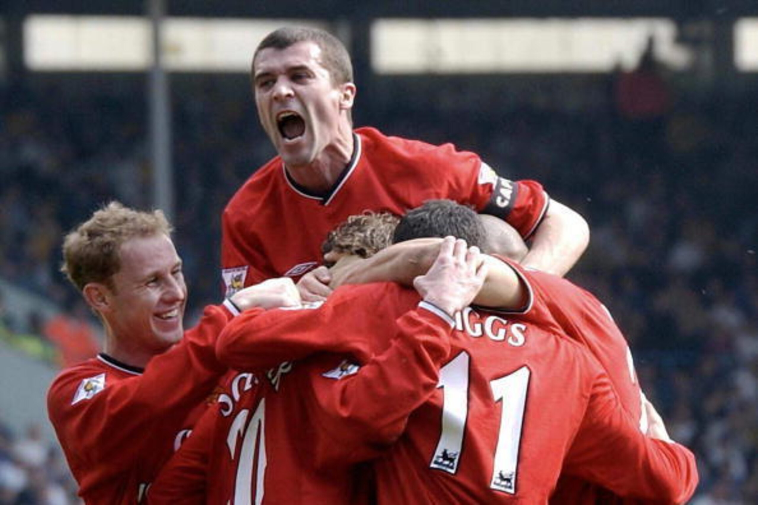 Leeds, UNITED KINGDOM:  (FILES) Manchester United captain Roy Keane (C facing) celebrates with team-mates after their first goal against Leeds during their premiereship soccer clash at Leeds in this 30 March 2002 file picture. Keane announced his retireme