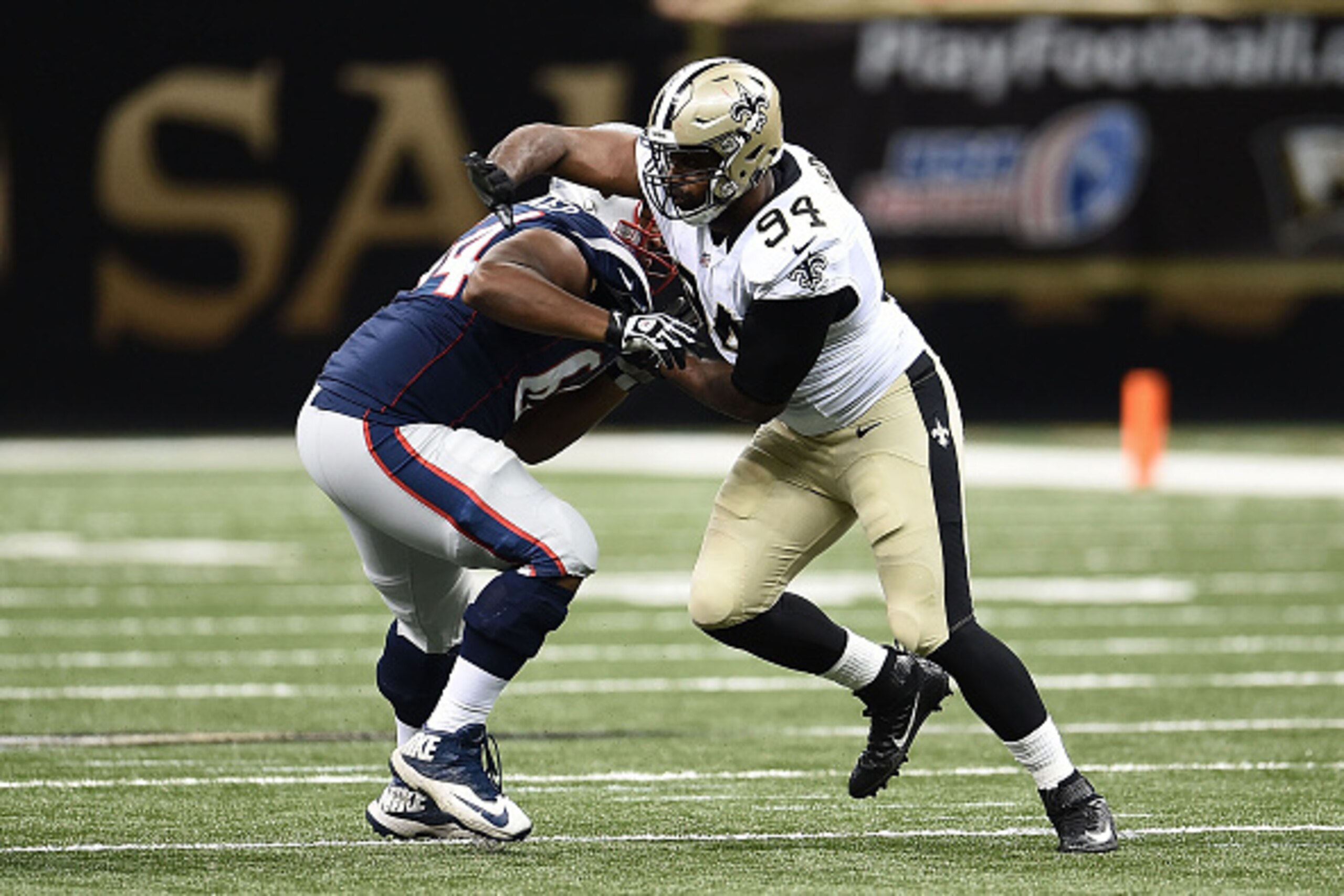 NEW ORLEANS, LA - AUGUST 22:  Cameron Jordan #94 of the New Orleans Saints works against Chris Barker #64 of the New England Patriots during a preseason game at the Mercedes-Benz Superdome on August 22, 2015 in New Orleans, Louisiana.  (Photo by Stacy Rev