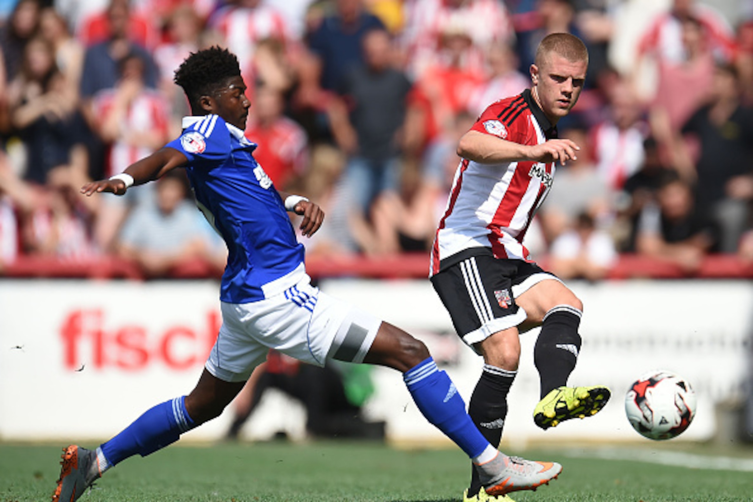 BRENTFORD, ENGLAND - AUGUST 08:  Jake Bidwell of Brentford and Ainsley Maitland-Niles of Ipswich Town in action during the Sky Bet Championship match between Brentford and Ipswich Town at Griffin Park on August 8, 2015 in Brentford, England.  (Photo by To
